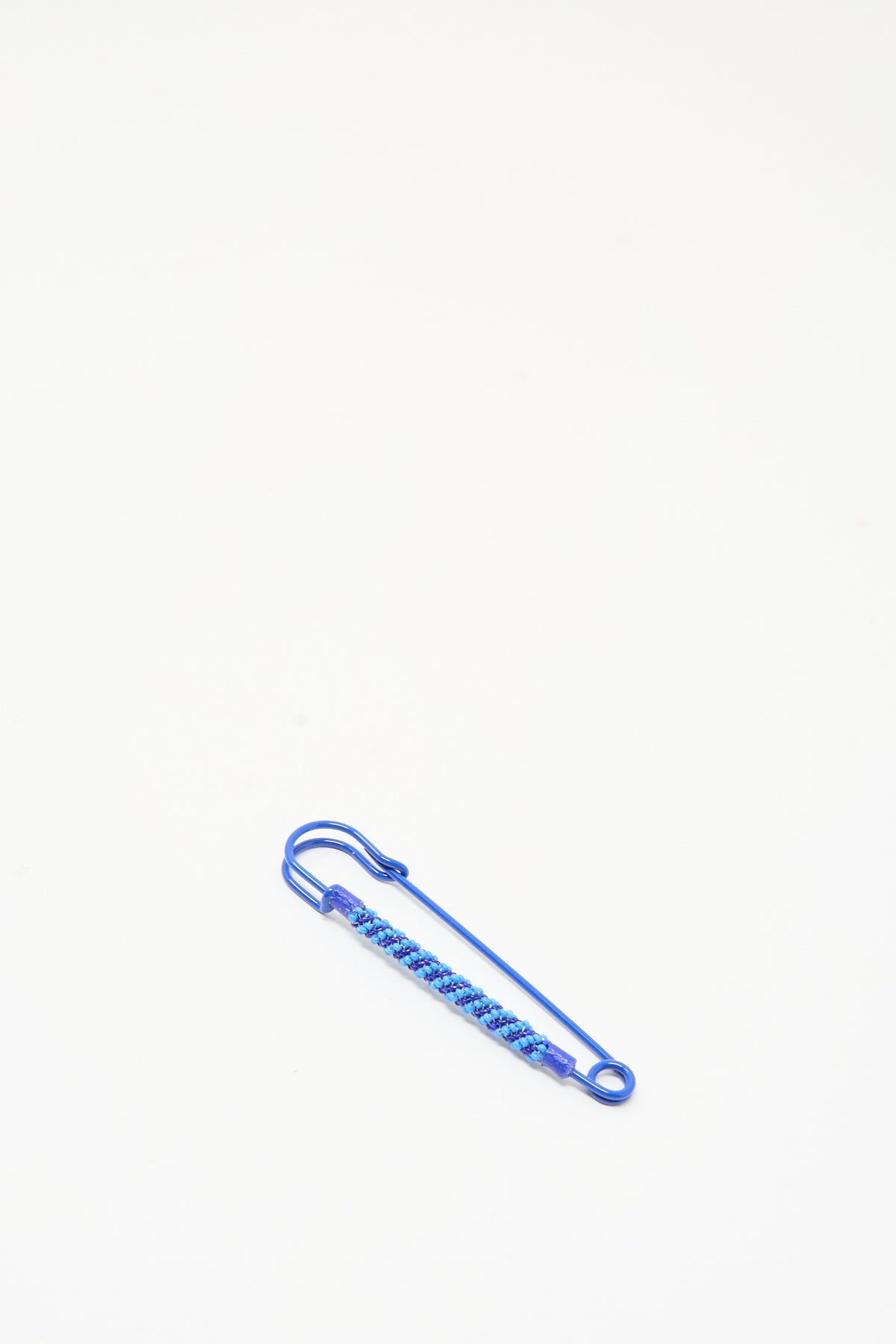Robin Mollicone Beaded Safety Pin in Blue, a blue color-coated steel safety pin wrapped with woven blue glass beads.