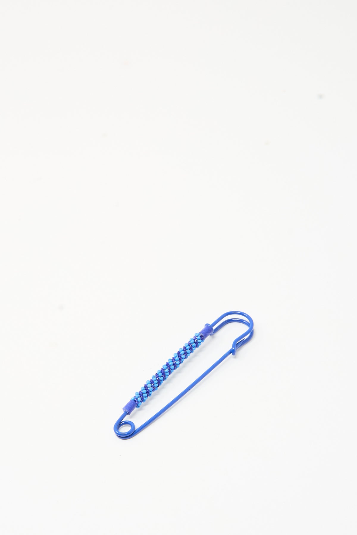 Robin Mollicone Beaded Safety Pin in Blue, a blue color-coated steel safety pin wrapped with small blue glass beads.