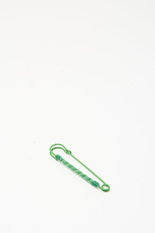 Robin Mollicone Beaded Safety Pin in Green, a color-coated steel safety pin partially covered with teal and green glass beads.