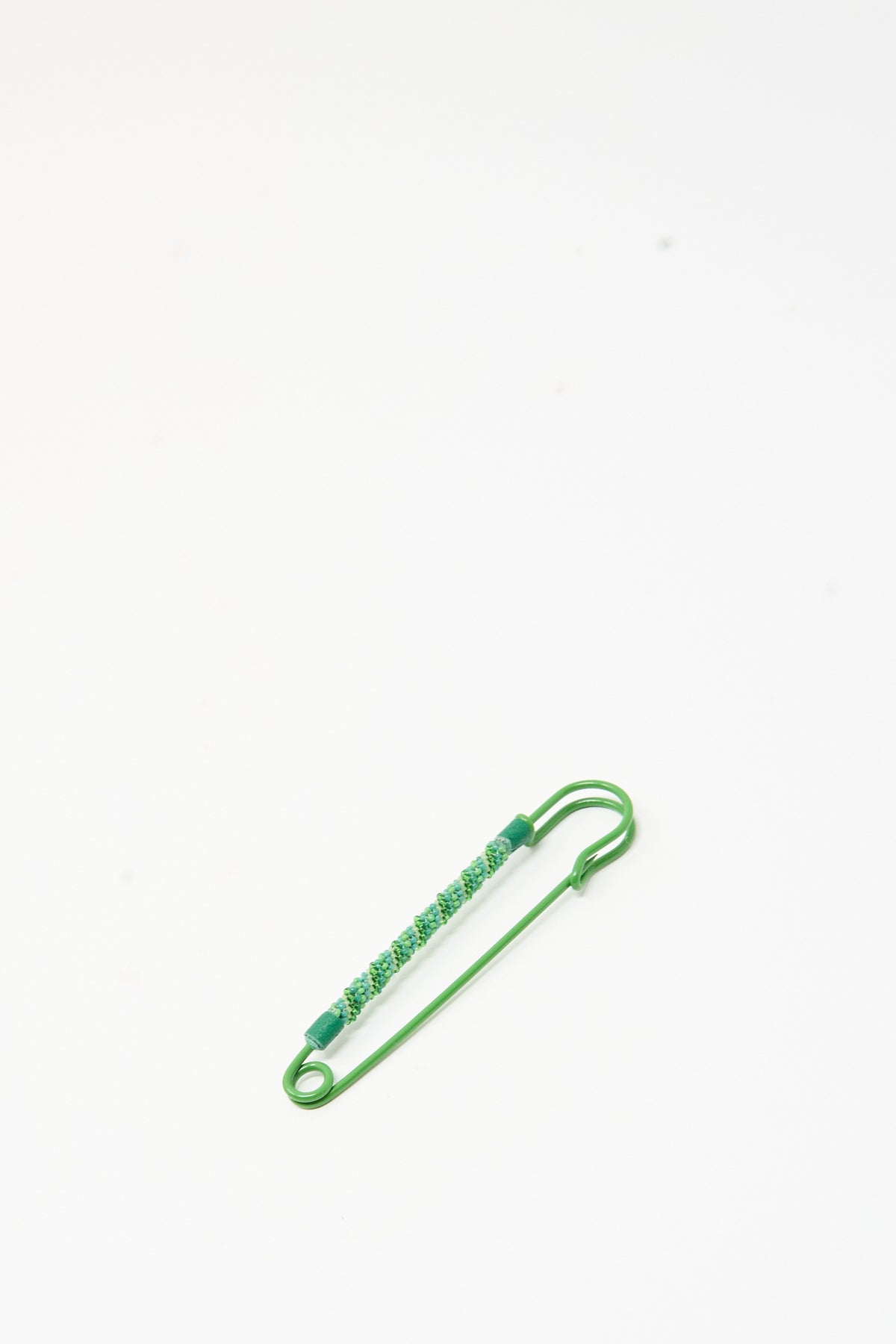 Robin Mollicone Beaded Safety Pin in Green featuring a green color coated steel pin with a beaded section in shades of green.