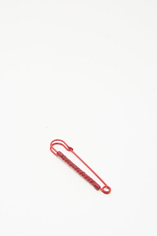 Robin Mollicone Beaded Safety Pin in Red: a red color-coated steel safety pin covered in small matching glass beads.