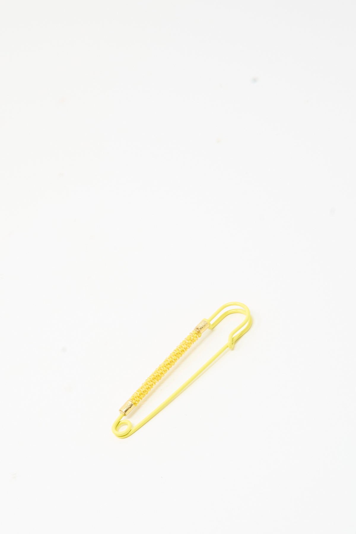 Robin Mollicone Beaded Safety Pin in Yellow, a color-coated steel safety pin with a central section wrapped in yellow glass beads.