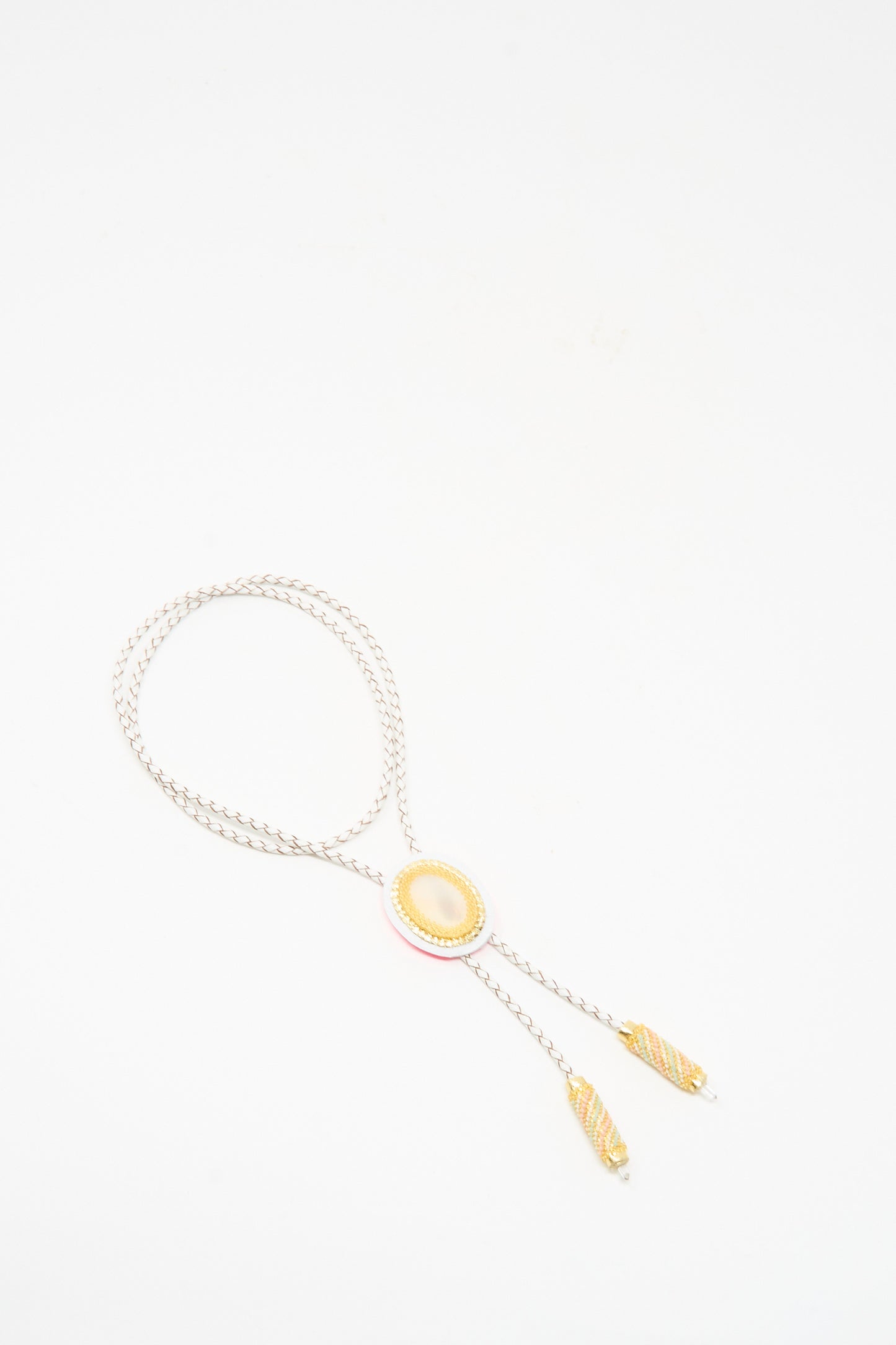 The Robin Mollicone Bolo Necklace in Mother of Pearl and Quartz features a yellow oval center, decorative gold-tone tips, subtle Mother of Pearl accents, and is handmade in NYC, shown on a white background.