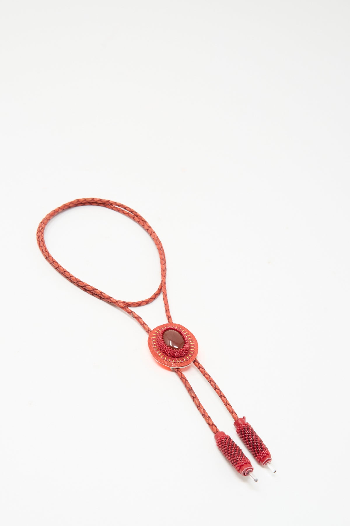 Robin Mollicone Bolo Necklace in Red Carnelian featuring a braided cord, a central oval stone pendant, and matching beaded end caps.