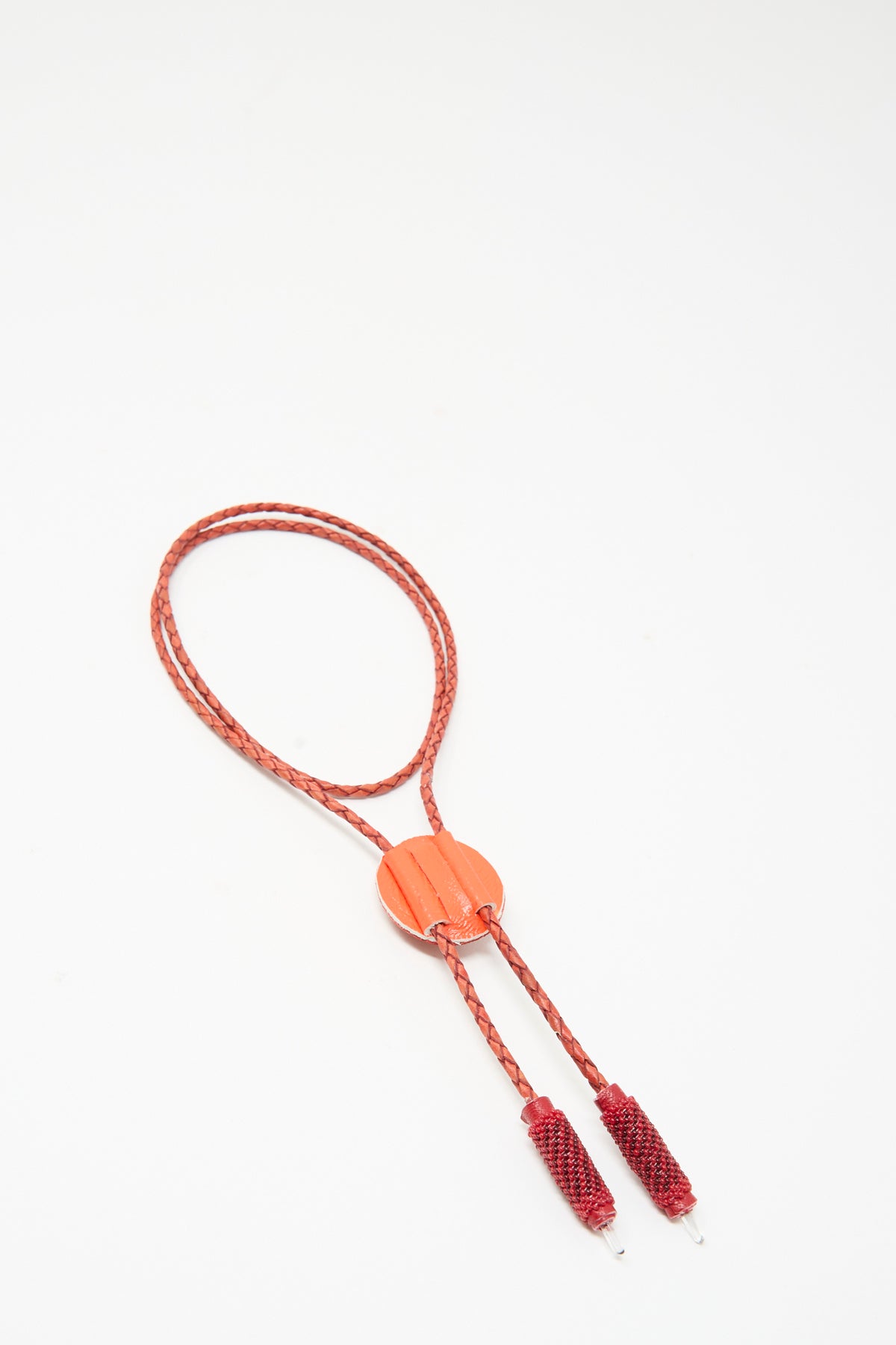 Robin Mollicone Bolo Necklace in Red Carnelian, featuring a handmade red braided leather cord with a central round stone slide and two matching beaded end caps.