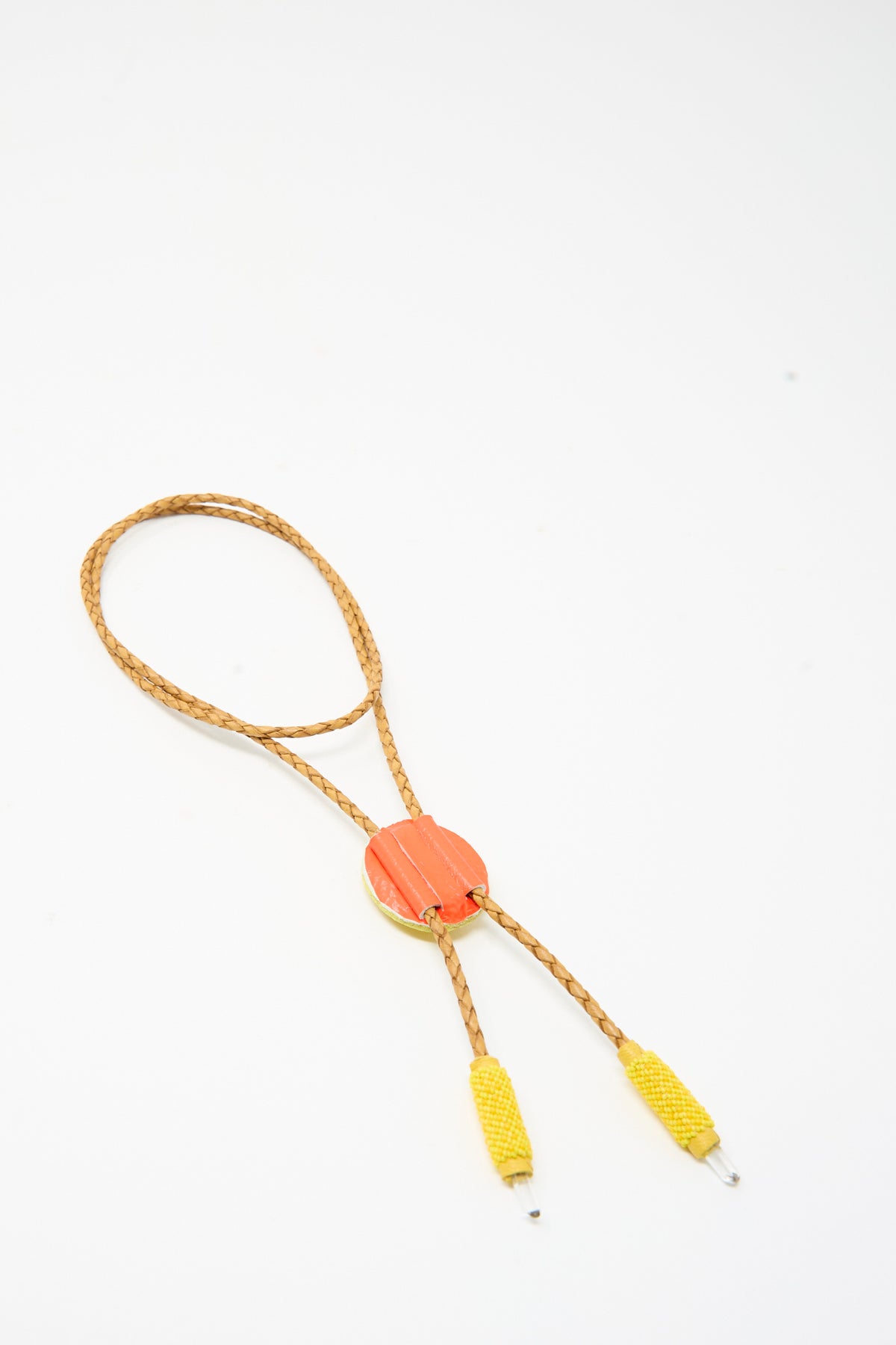 Robin Mollicone Bolo Necklace in Yellow Calcite featuring a braided cord, a round orange pendant, and yellow cylindrical aglets.
