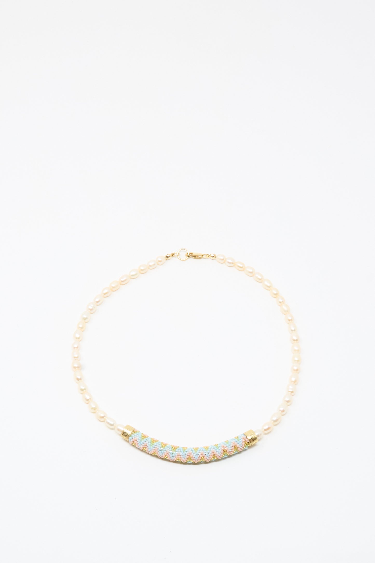 The Robin Mollicone Fresh Water Pearl Beaded Bar Necklace is a handmade piece featuring small pearls and a curved, multicolored beaded centerpiece, beautifully displayed on a plain white background.