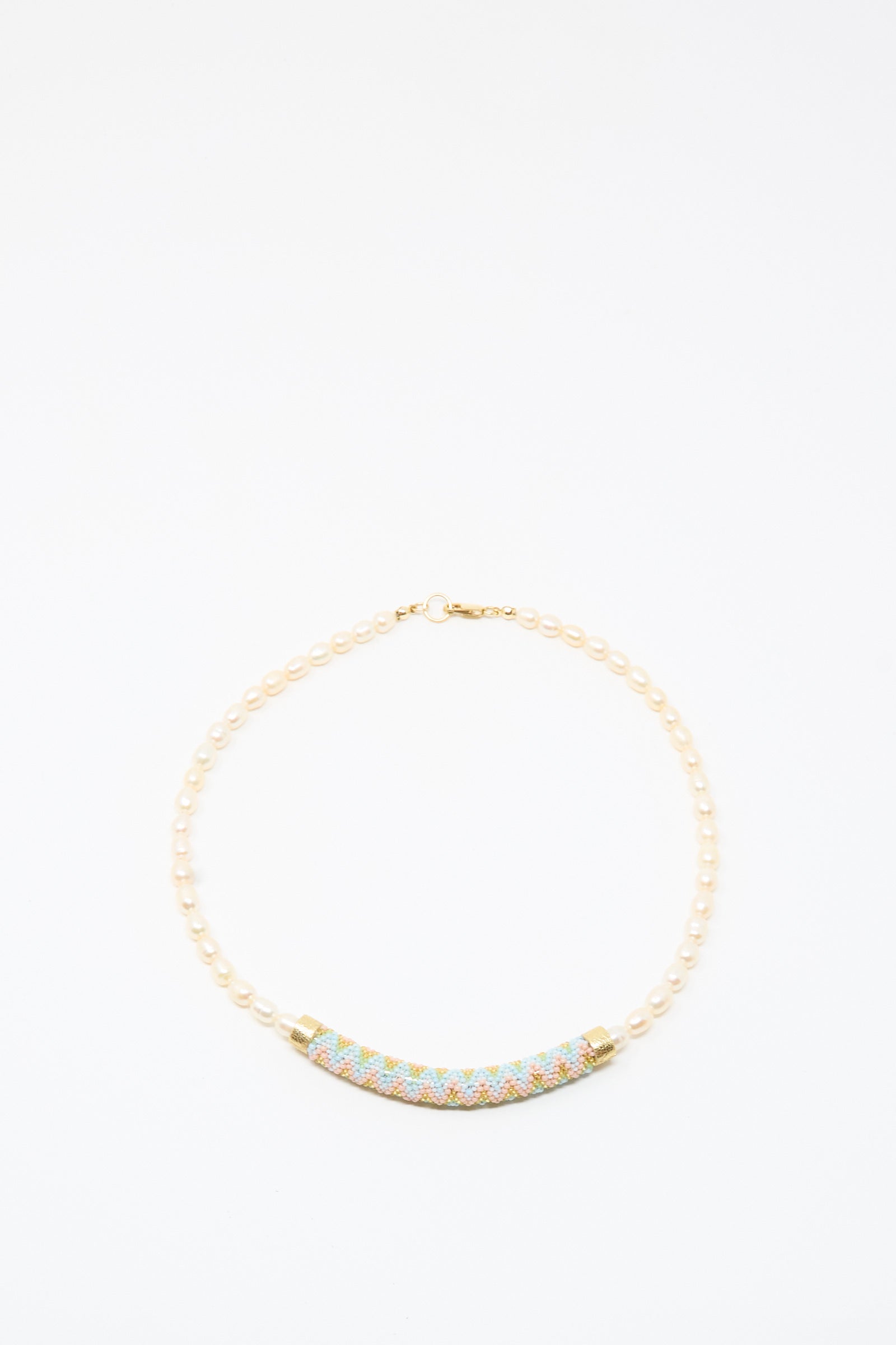 The Robin Mollicone Fresh Water Pearl Beaded Bar Necklace is a handmade piece featuring small pearls and a curved, multicolored beaded centerpiece, beautifully displayed on a plain white background.