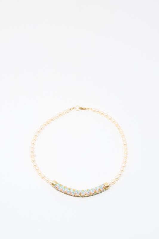The Robin Mollicone Fresh Water Pearl Beaded Bar Necklace is a handmade piece featuring small pearls and a curved, multicolored beaded centerpiece, beautifully displayed on a plain white background.