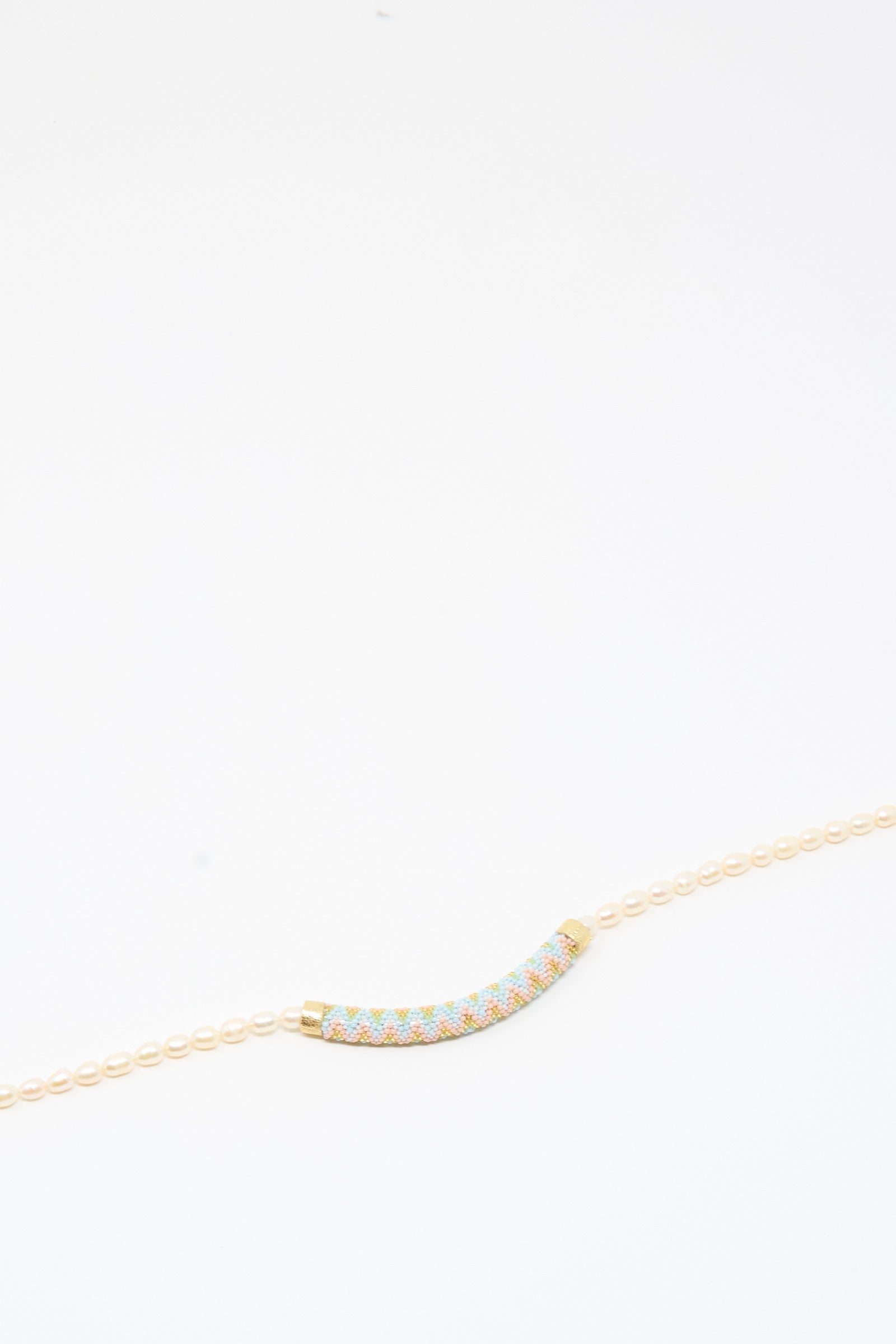 Fresh Water Pearl Beaded Bar Necklace by Robin Mollicone displayed on a plain white background—a striking handmade piece featuring a curved, multicolored beaded bar pendant that adds a vibrant touch to any collection.