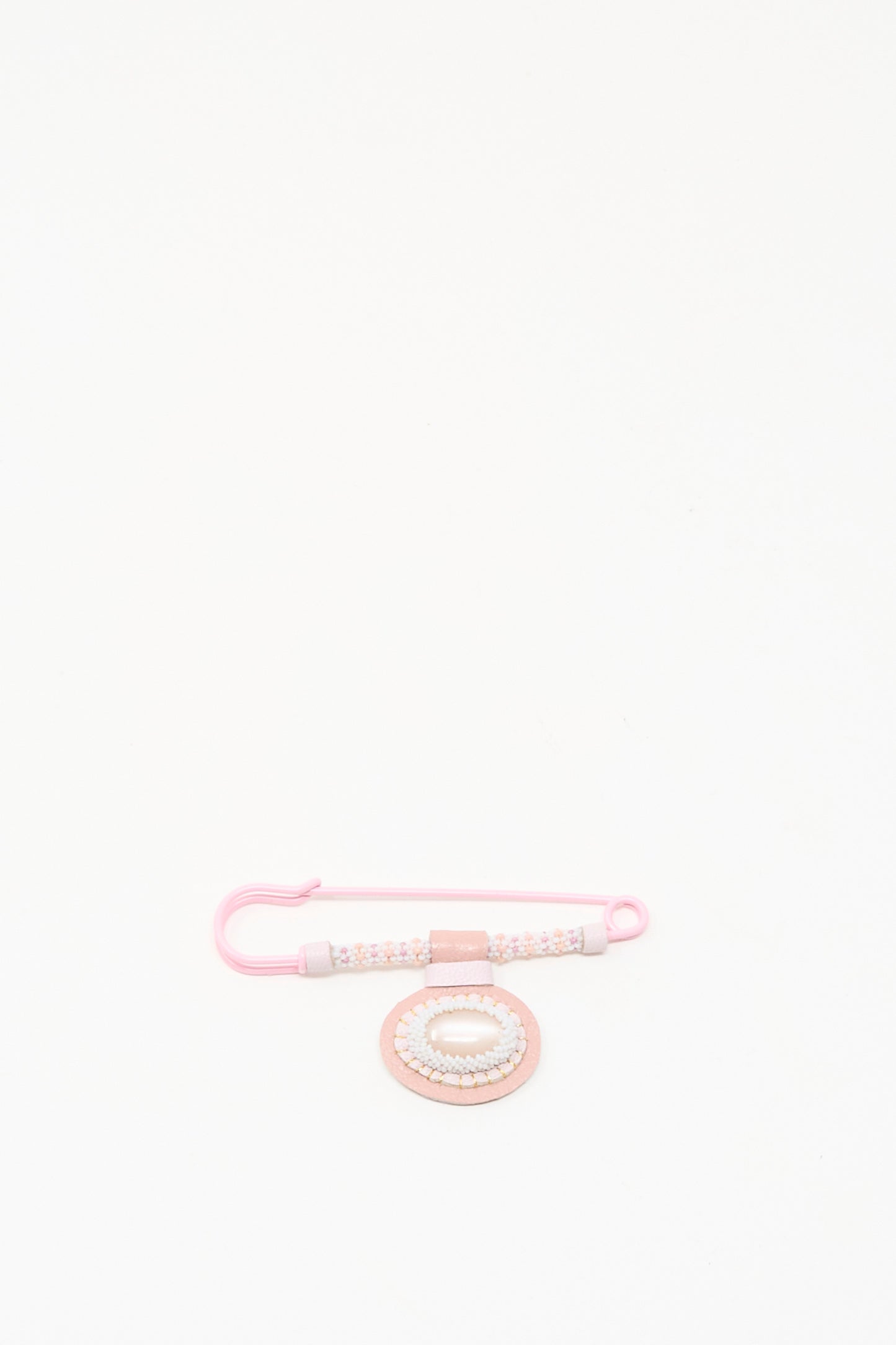 The Robin Mollicone Gem Drop Brooch in Pink Moonstone, handmade in NYC, features a beaded safety pin and a matching circular accessory in pink tones, displayed on a plain white background.