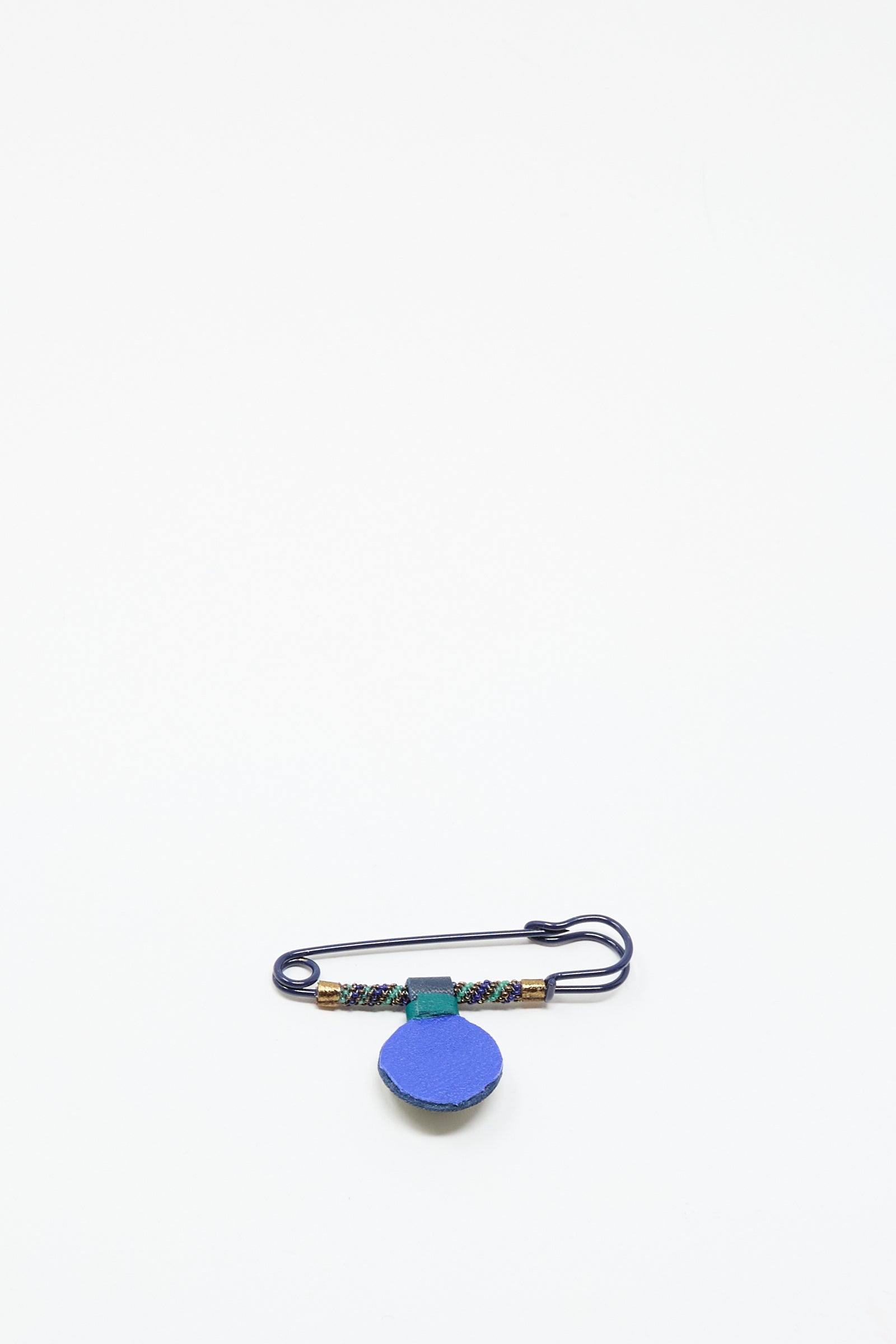 The Gem Drop Safety Pin in Blue with Azurite by Robin Mollicone, featuring a blue circular charm and multicolored antique glass beads, is shown on a plain white background.