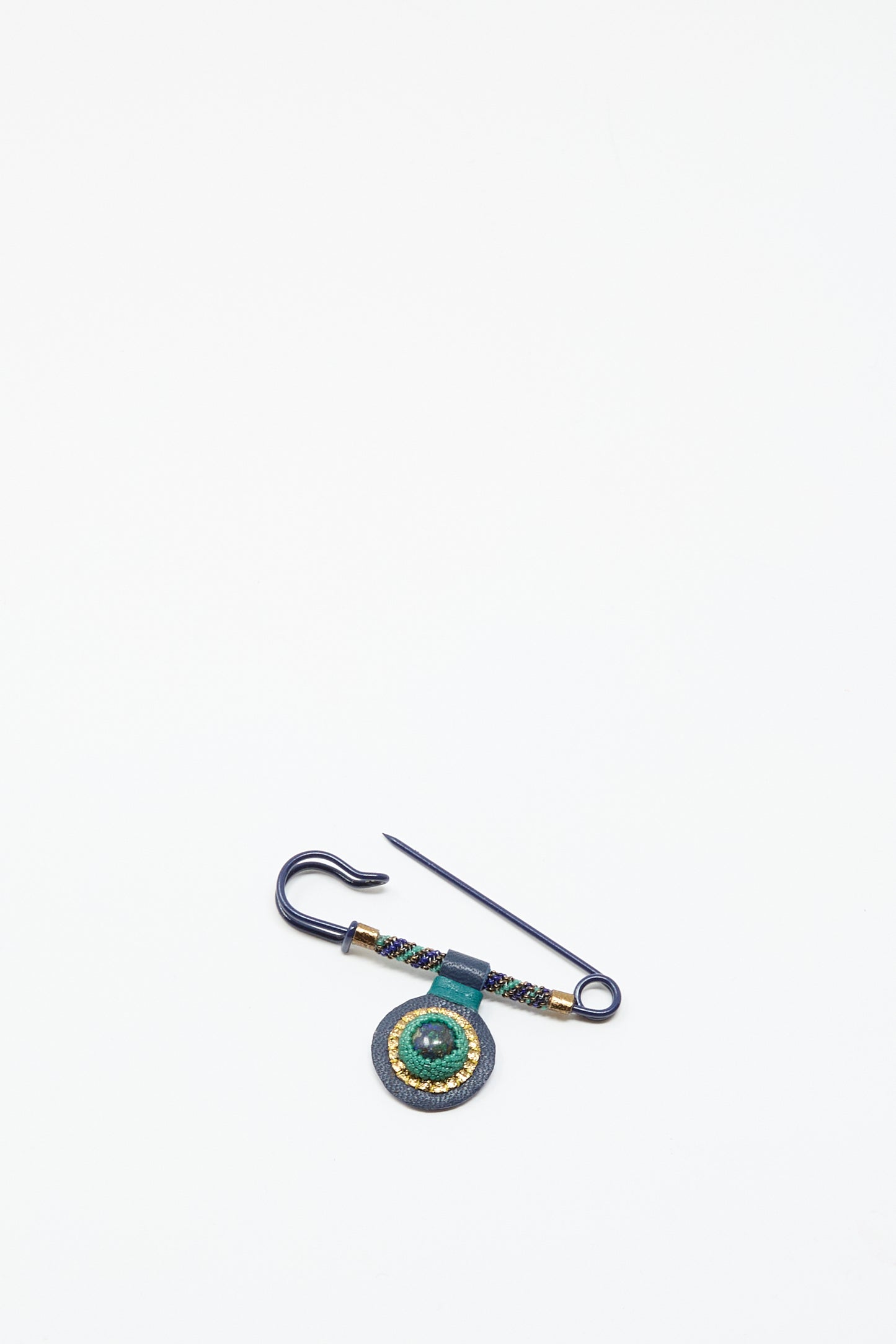 The Robin Mollicone Gem Drop Safety Pin in Blue with Azurite features a hook and a round, beaded green and gold ornament made from antique glass beads, displayed on a plain white background.