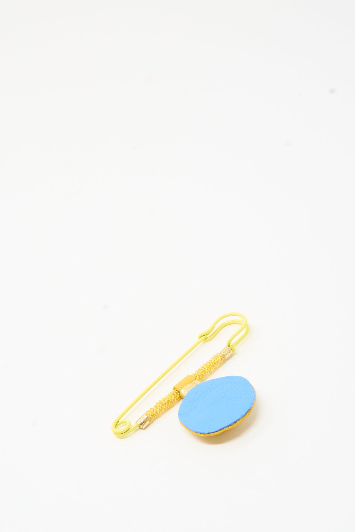 Robin Mollicone Gem Drop Safety Pin in Yellow Calcite featuring a yellow safety pin with an attached blue circular pendant.