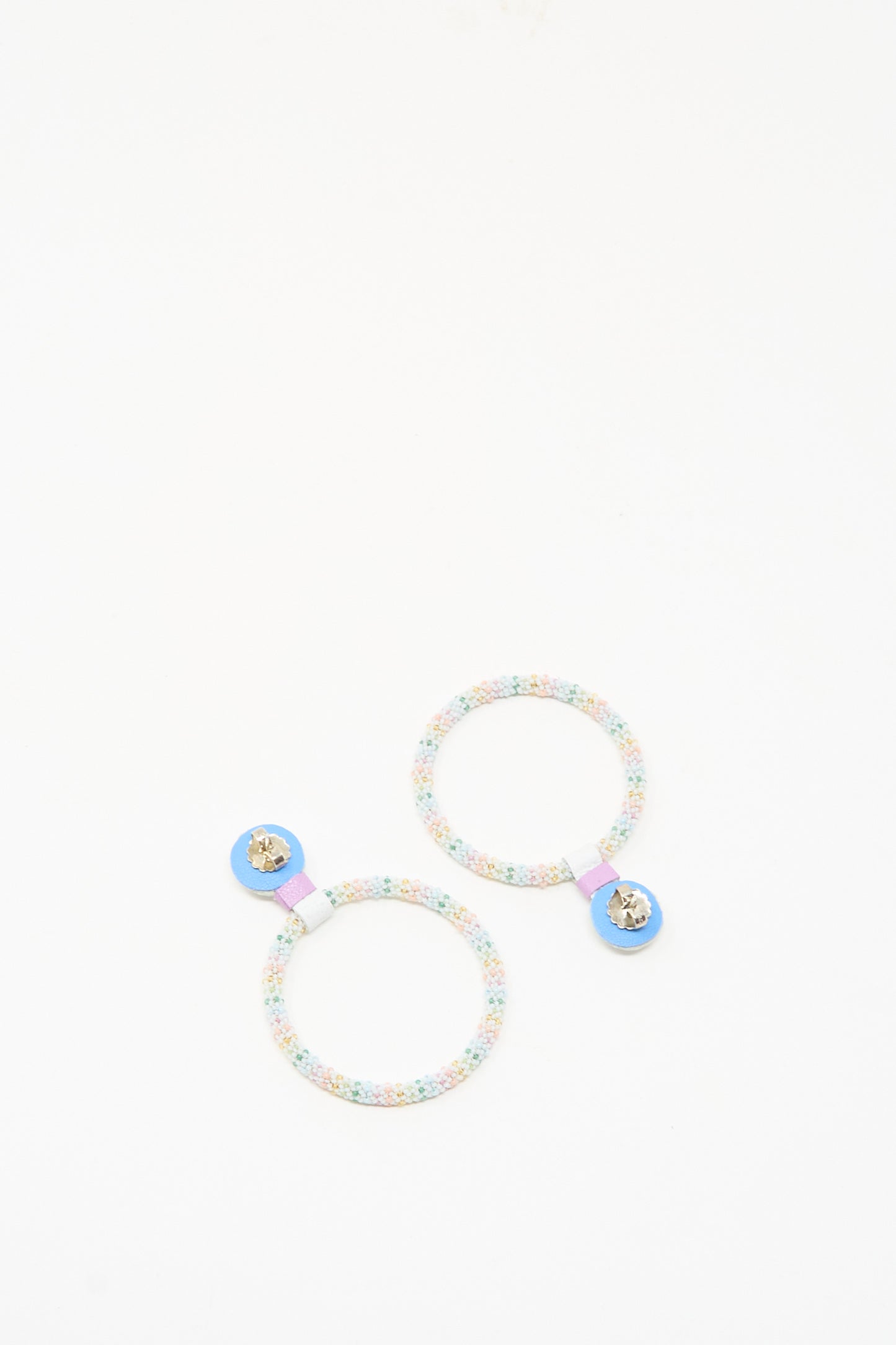 The Large Beaded Hoops in Rainbow Moonstone by Robin Mollicone feature colorful beads and blue accents, reminiscent of bejeweled hair accessories, and are showcased against a plain white background.