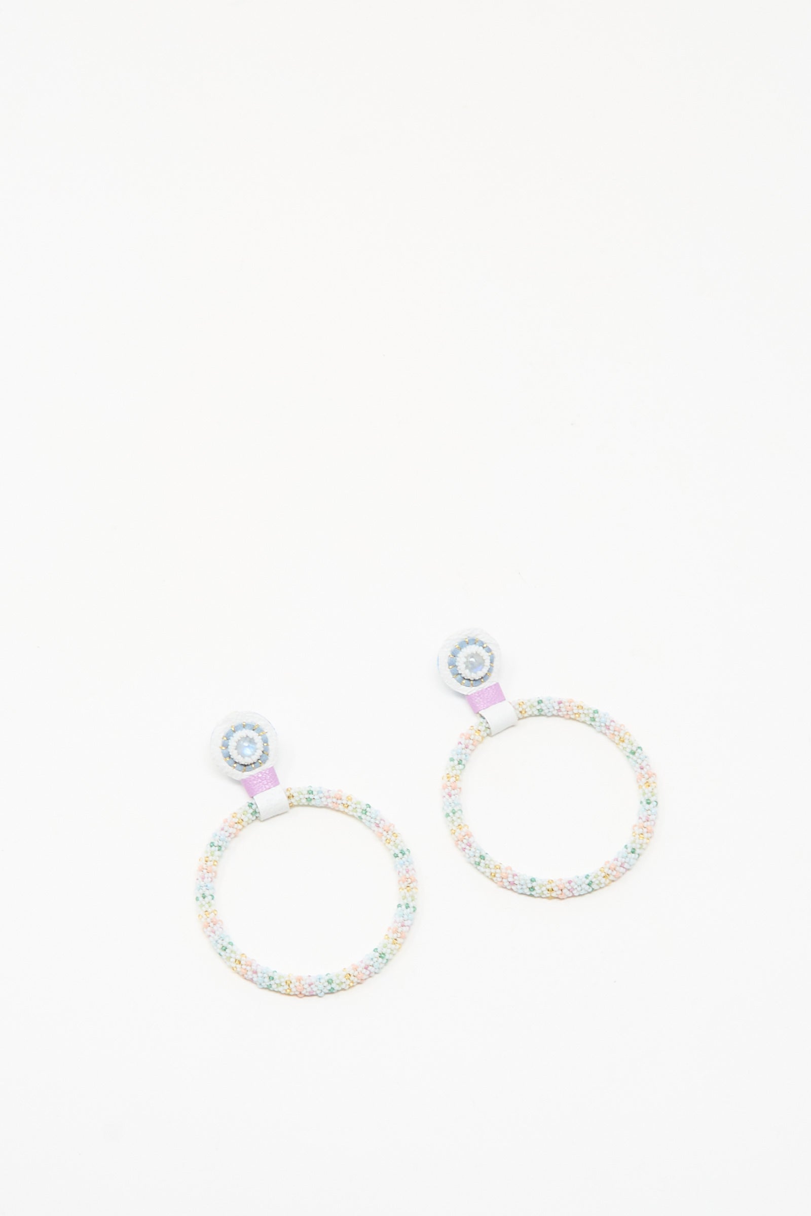 The Large Beaded Hoops in Rainbow Moonstone by Robin Mollicone are handmade earrings with pastel beads and a circular design, featuring a small stud and larger loop—ideal for adding subtle charm to any outfit.