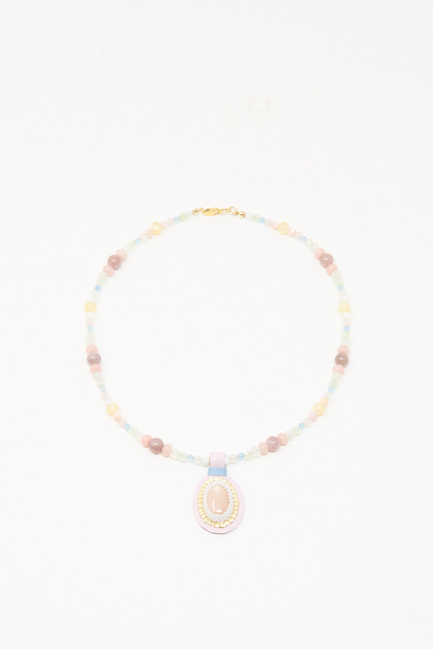 The Love Bead Charm Necklace in Pink Moonstone by Robin Mollicone features vintage pastel glass beads and a central pink moonstone pendant, beautifully displayed on a white background.