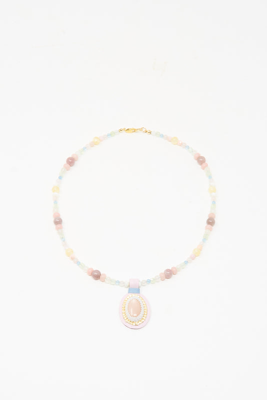 The Love Bead Charm Necklace in Pink Moonstone by Robin Mollicone features vintage pastel glass beads and a central pink moonstone pendant, beautifully displayed on a white background.