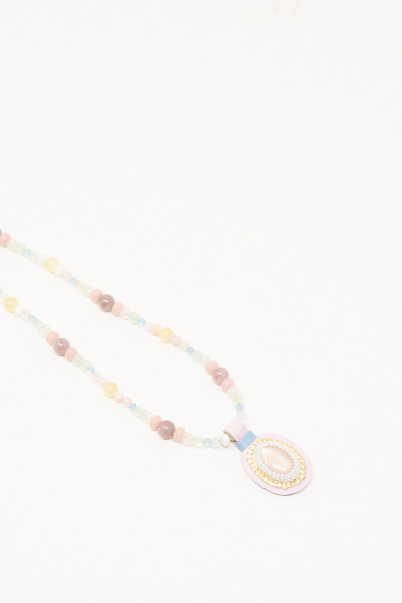 The Love Bead Charm Necklace in Pink Moonstone by Robin Mollicone features pastel vintage glass beads and a pink moonstone pendant, shown on a white background.