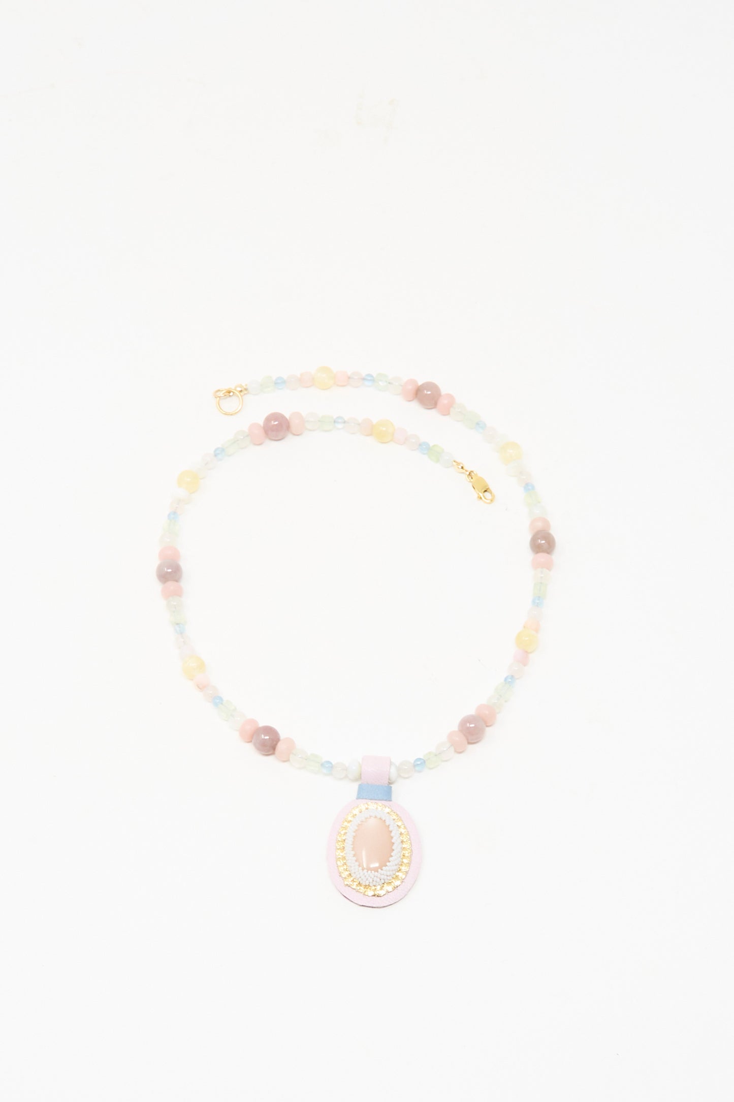 The Robin Mollicone Love Bead Charm Necklace in Pink Moonstone features pastel vintage glass beads and a central pink moonstone pendant, shown on a white background.