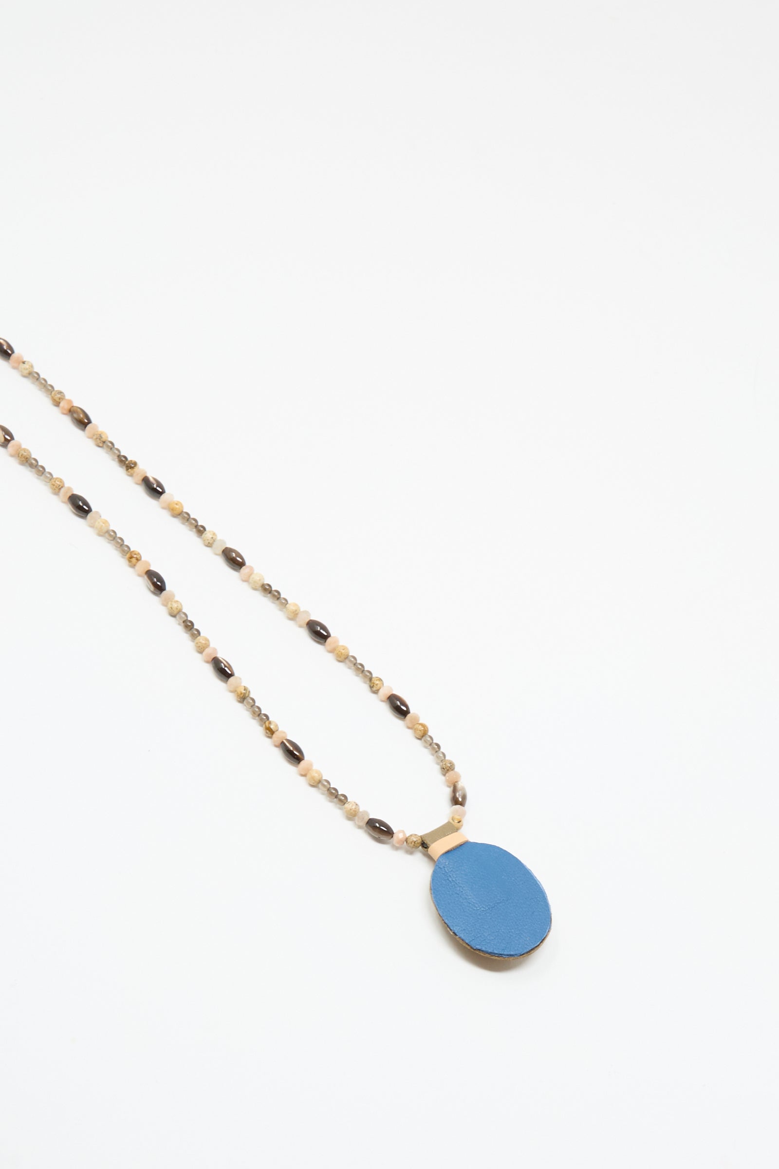 The Robin Mollicone Love Bead Necklace in Brown features small brown and beige beads with a large round picture jasper charm, handmade in NYC and shown on a white background.