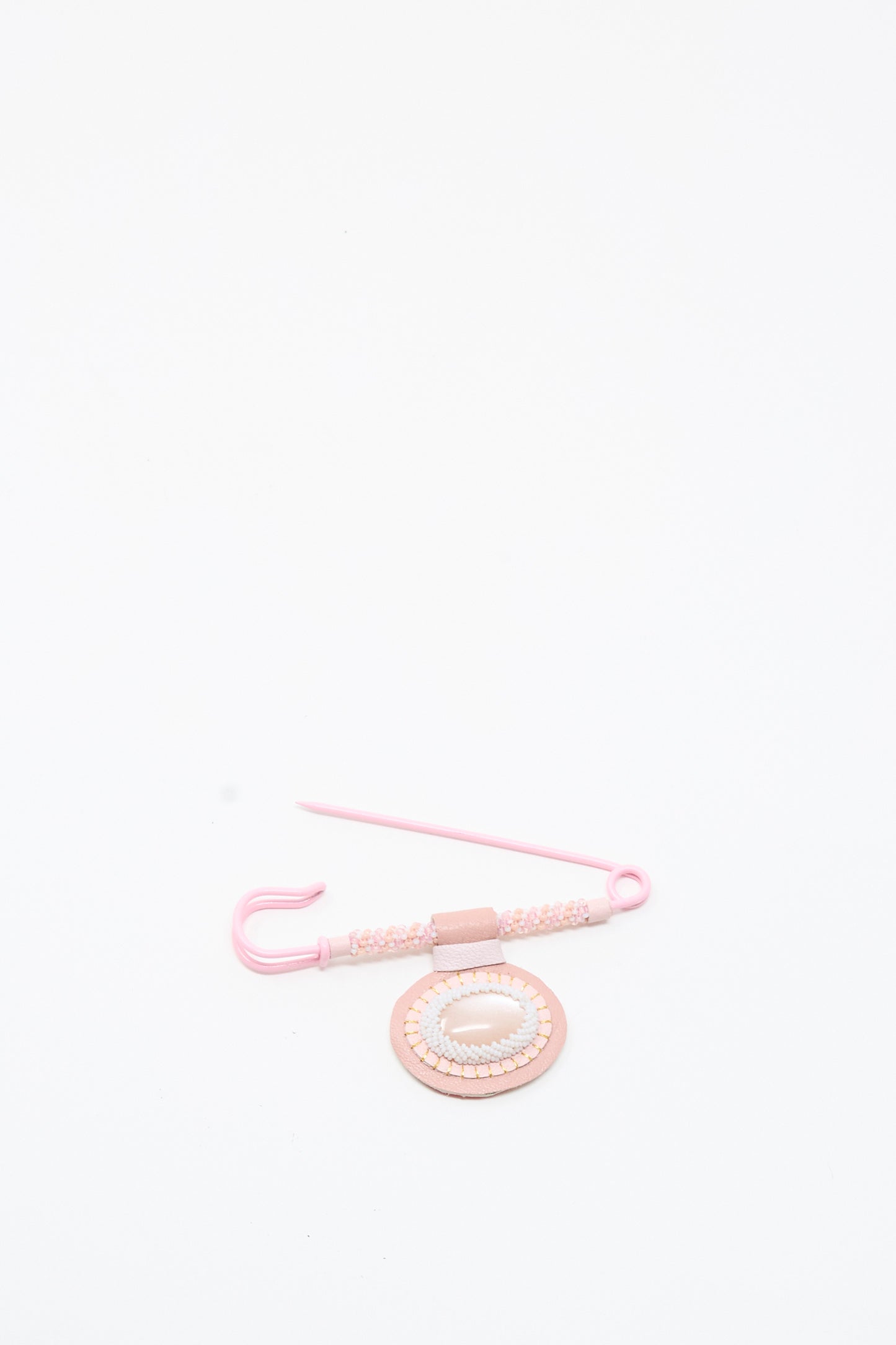 A Moonstone Gem Drop Brooch in Pink by Robin Mollicone—handmade in NYC—is arranged on a plain white background.