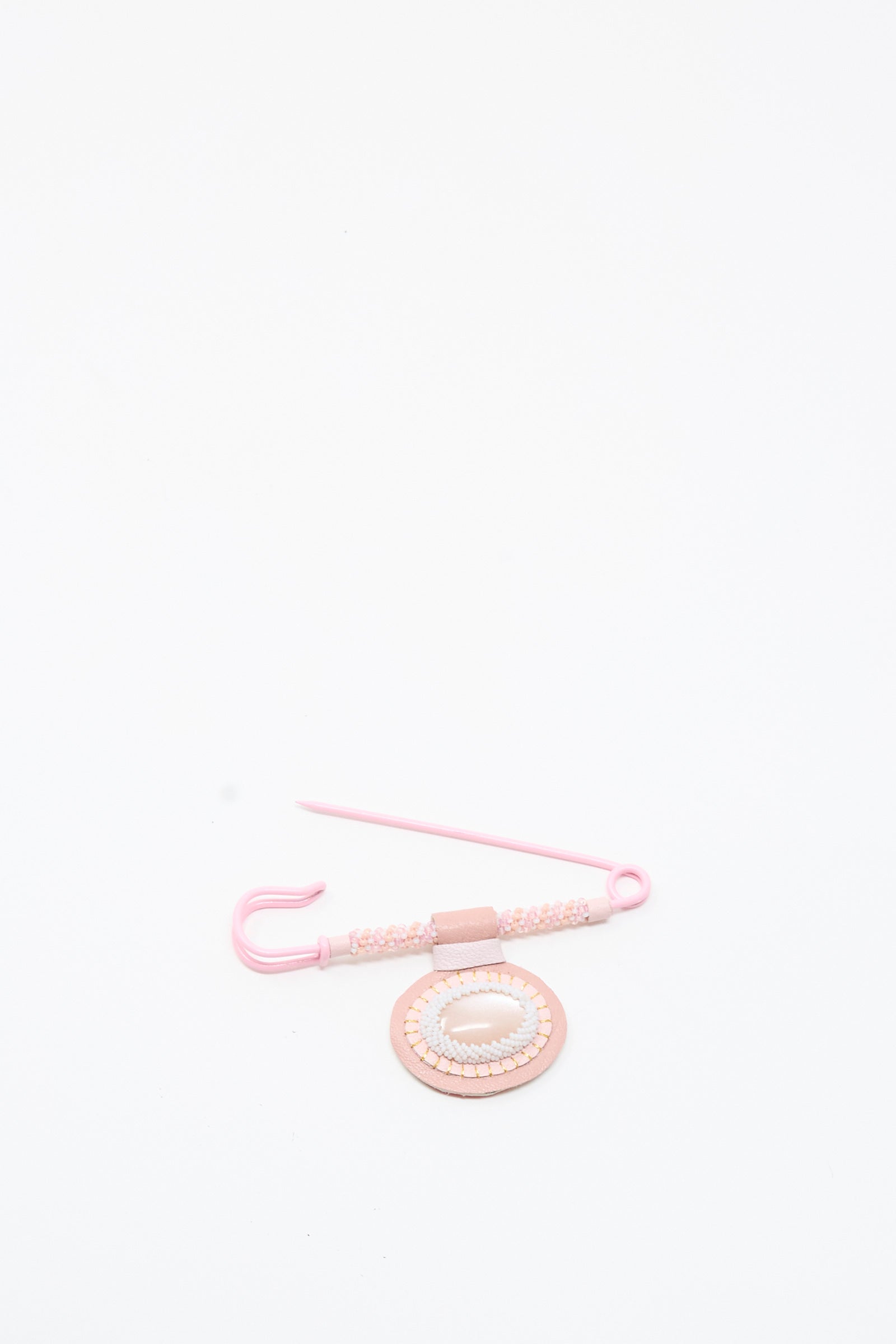 A Moonstone Gem Drop Brooch in Pink by Robin Mollicone—handmade in NYC—is arranged on a plain white background.