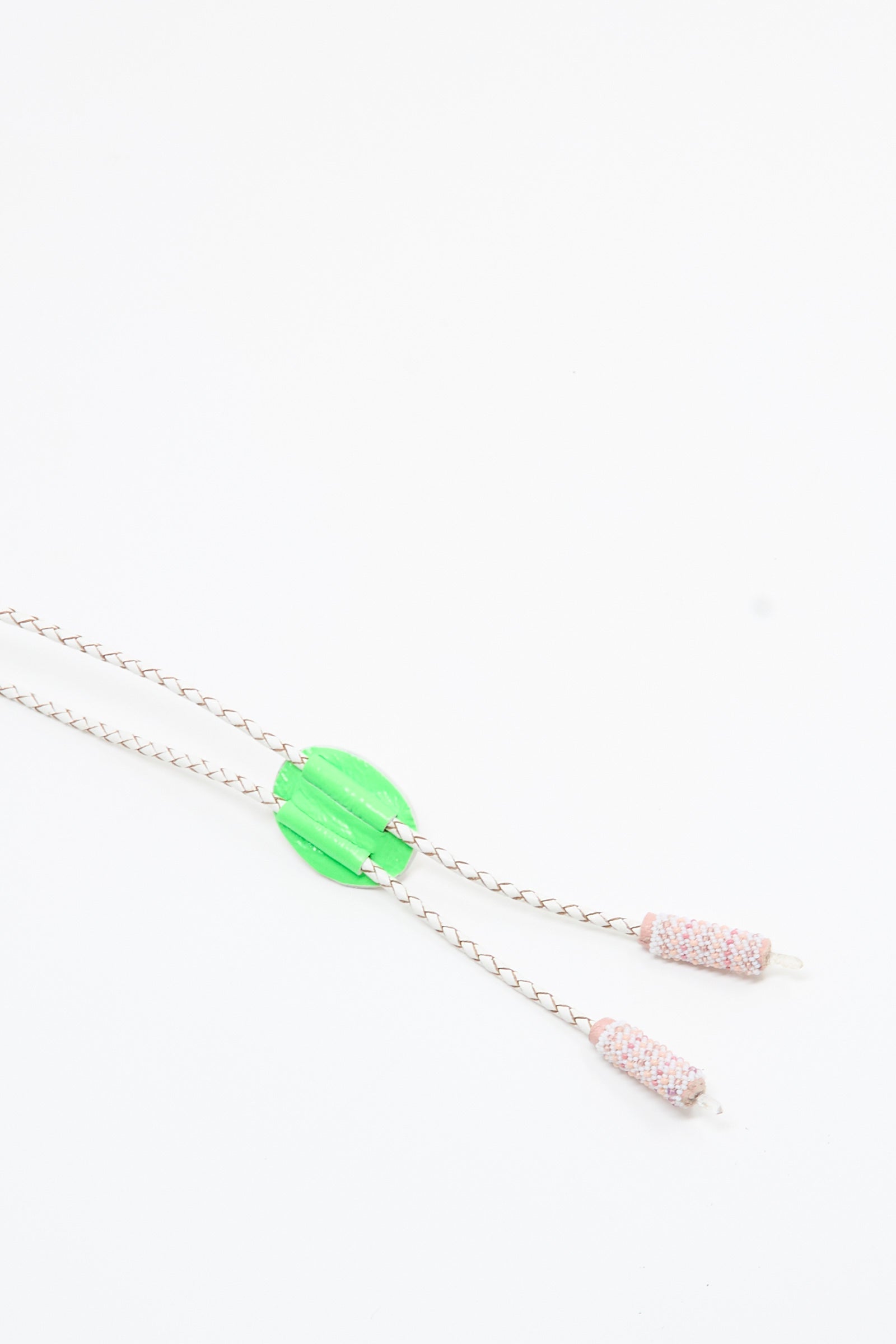 The Moonstone, Quartz Bolo Necklace in Pink and White by Robin Mollicone features a handmade silver chain with a vibrant green circular centerpiece and two woven pink-and-white tube pendants at each end, evoking the style of a modern bolo tie, displayed on a white background.