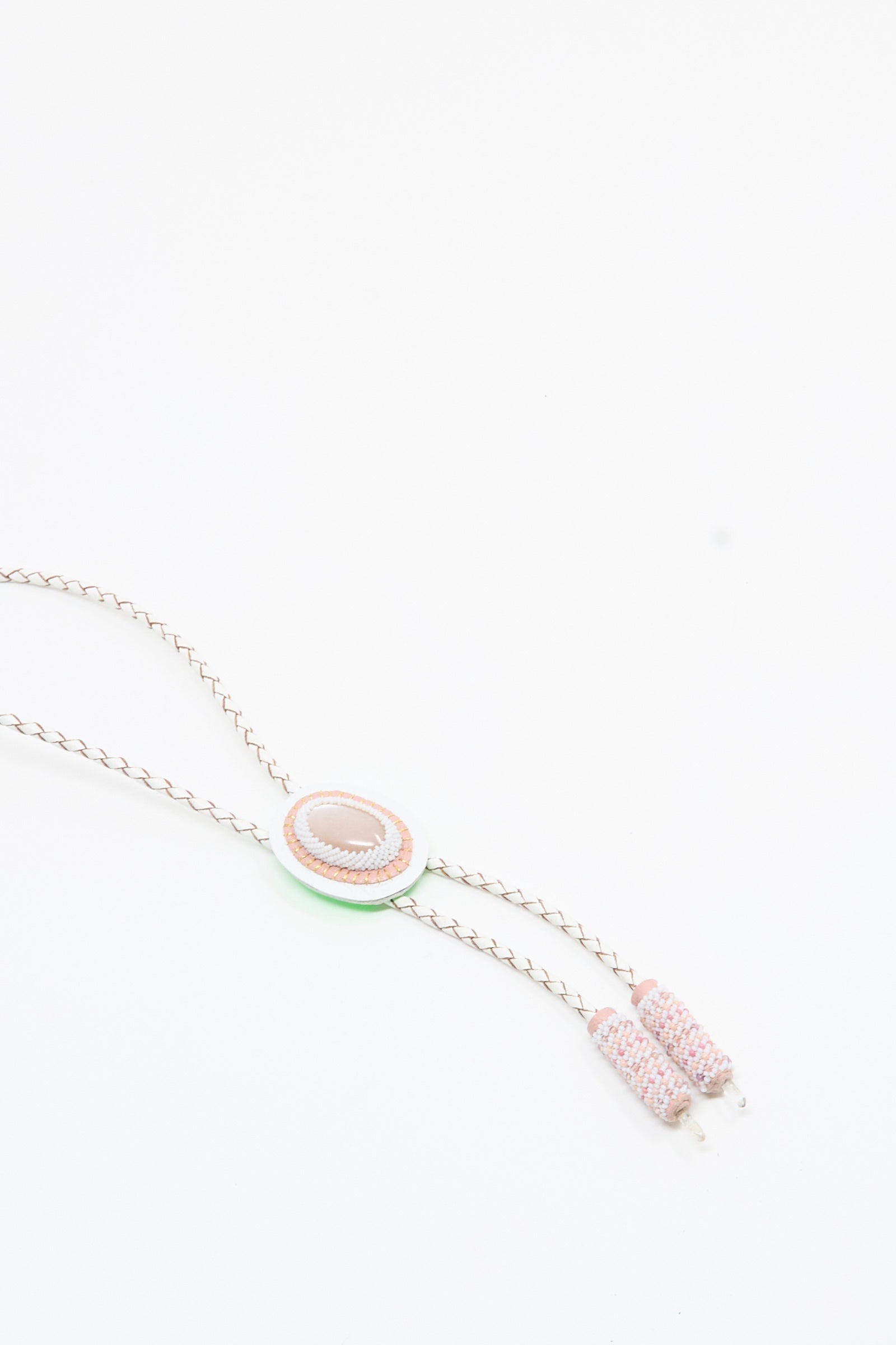 A delicate Moonstone and Quartz bolo necklace in pink and white by Robin Mollicone, featuring a pink moonstone oval centerpiece and two pastel beaded tassels, displayed on a white background.