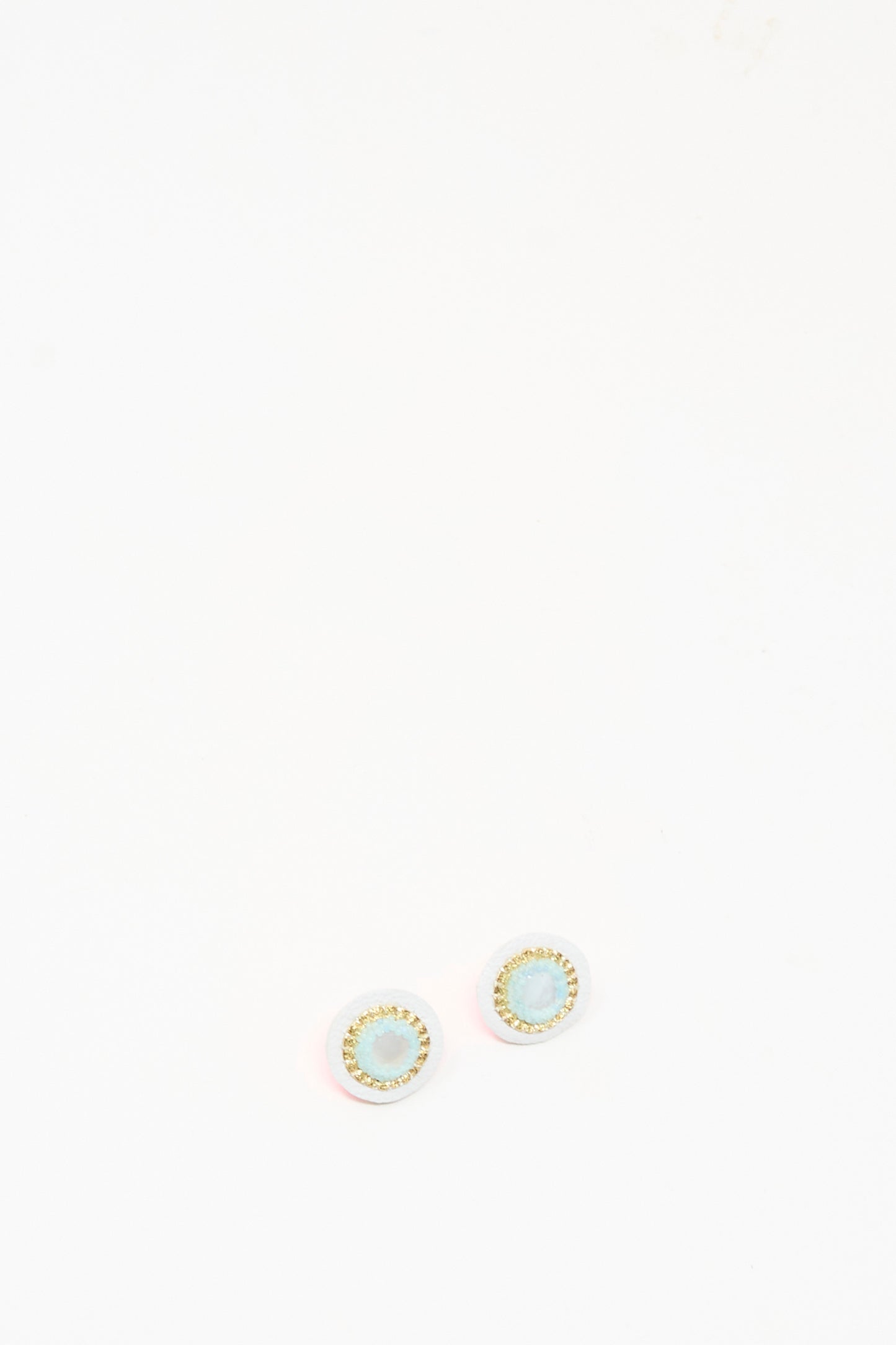 The Robin Mollicone Stud Earrings in Mother of Pearl feature handmade design with light blue centers and gold-colored edges, shown against a plain white background.