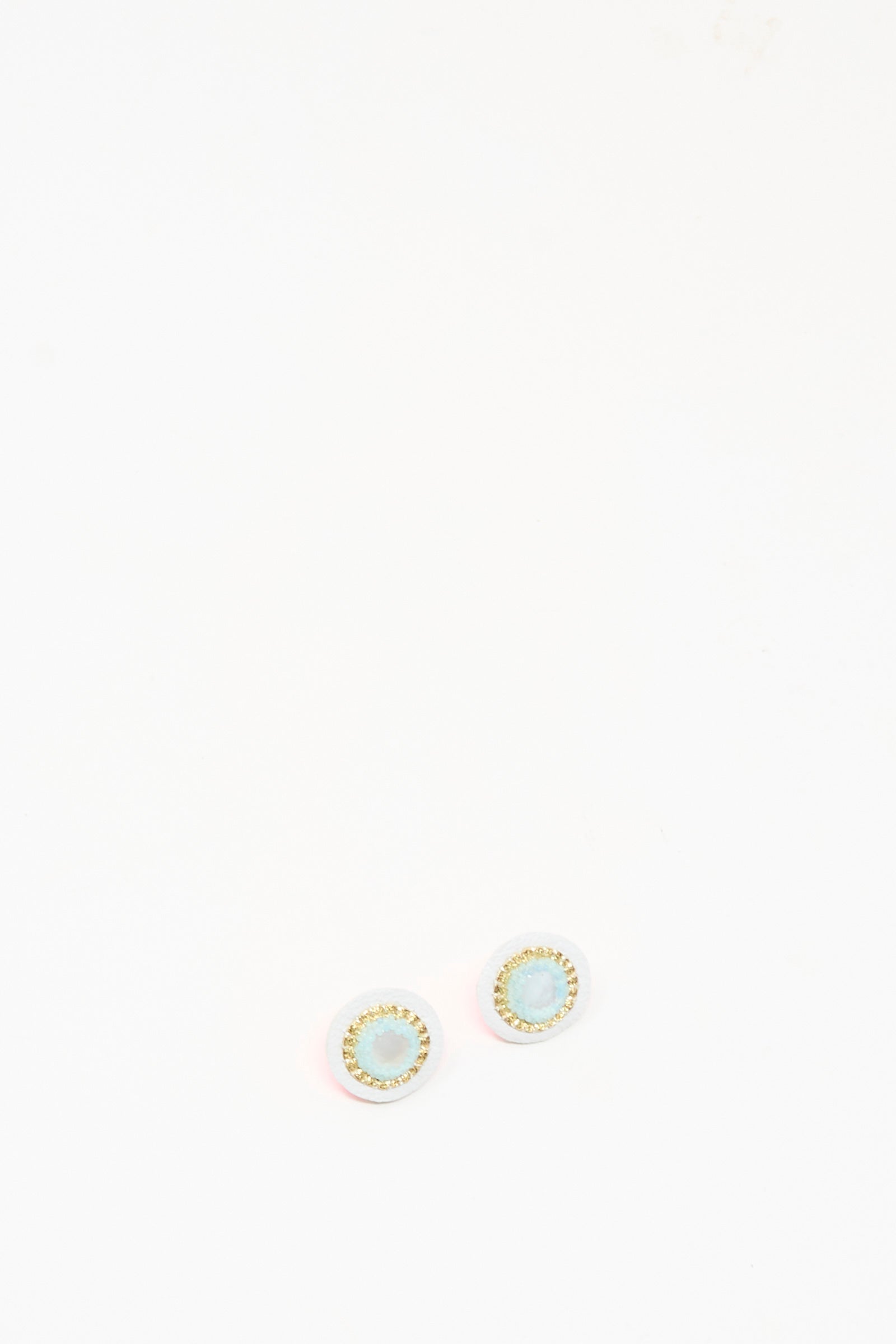 The Robin Mollicone Stud Earrings in Mother of Pearl feature handmade design with light blue centers and gold-colored edges, shown against a plain white background.