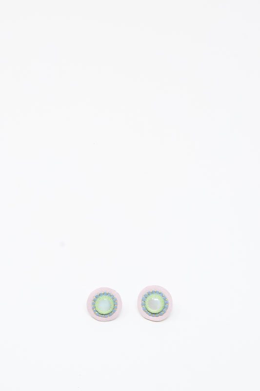 A pair of handmade Robin Mollicone Mother of Pearl Stud Earrings in Blue and Green, featuring round, iridescent green and blue centers with light-colored borders, displayed on a plain white background.