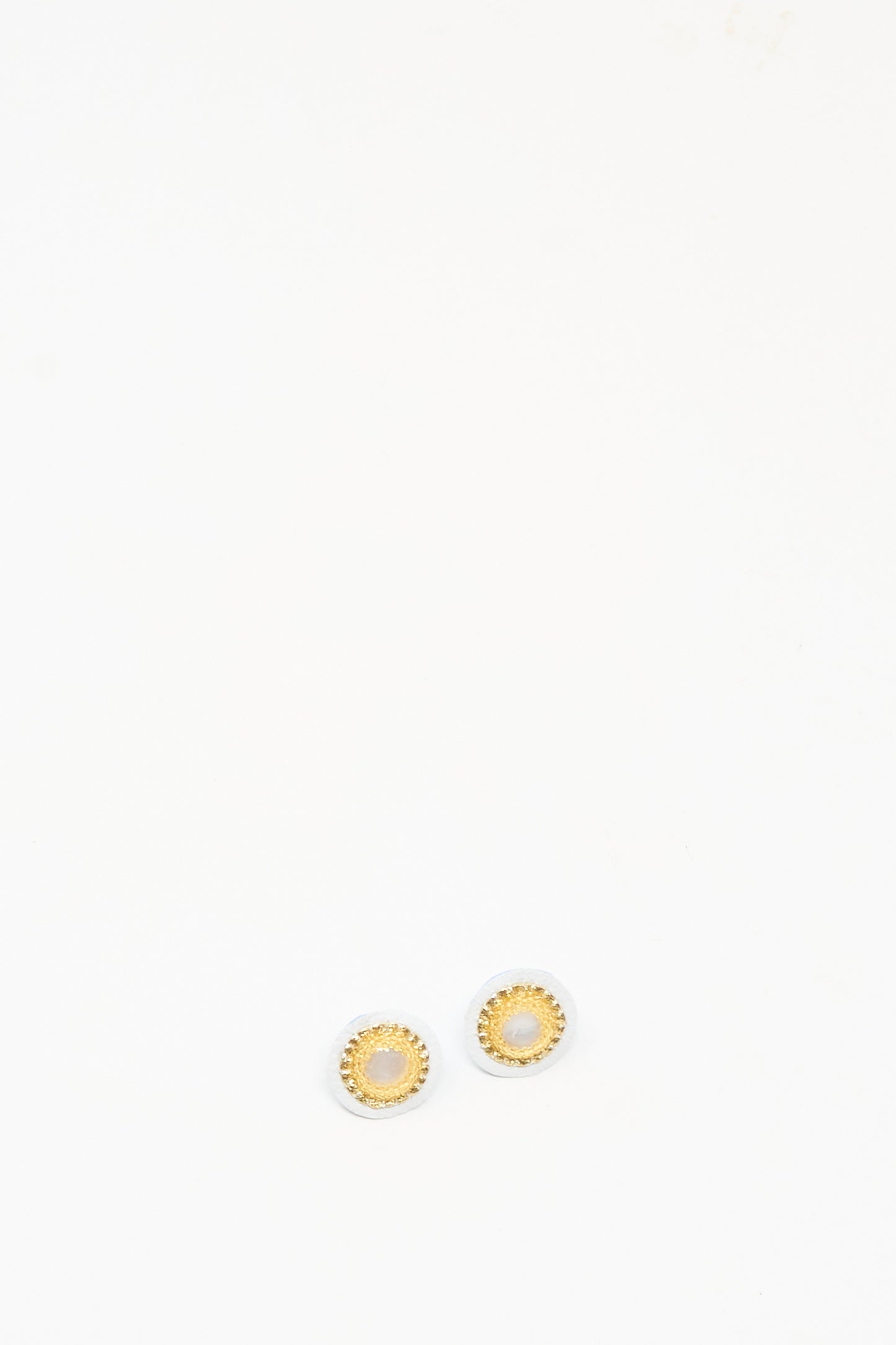 The Robin Mollicone Mother of Pearl Stud Earrings in Gold are small, round gold studs with elegant mother of pearl centers—perfect handmade earrings for everyday style. Displayed on a plain white background.