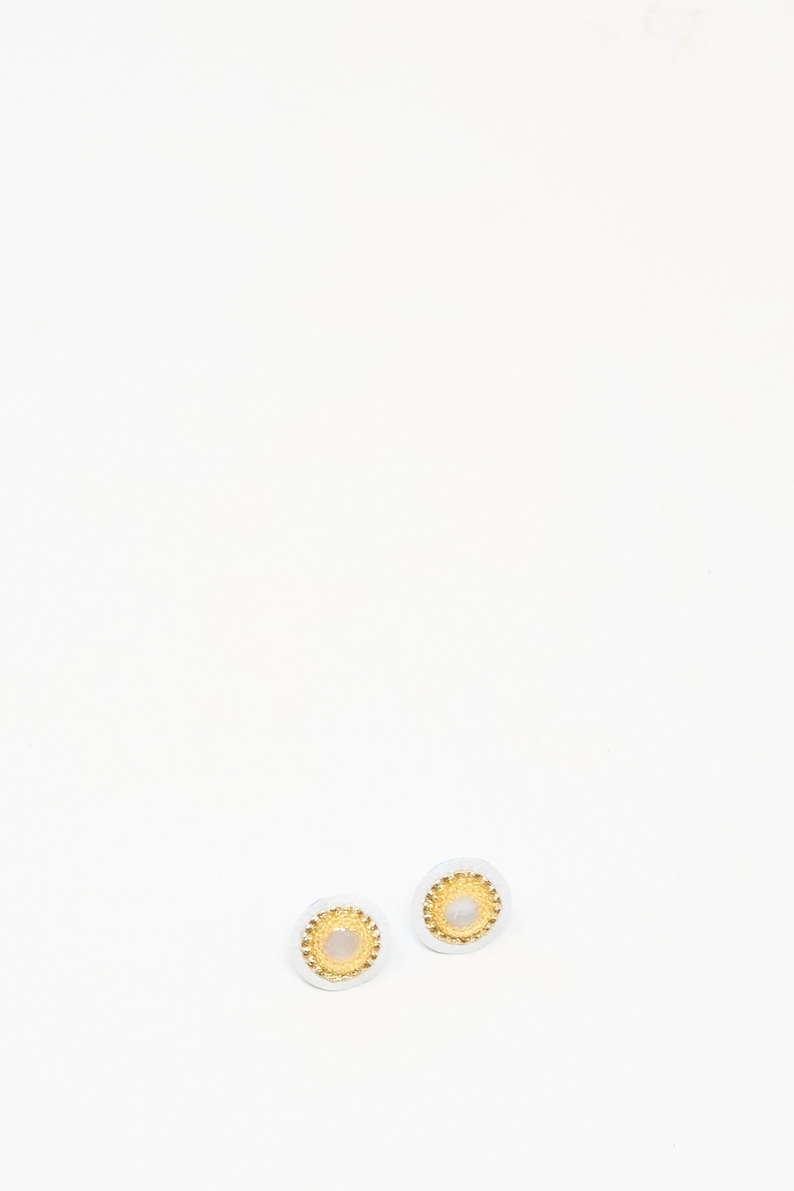 The Robin Mollicone Mother of Pearl Stud Earrings in Gold are small, round gold studs with elegant mother of pearl centers—perfect handmade earrings for everyday style. Displayed on a plain white background.