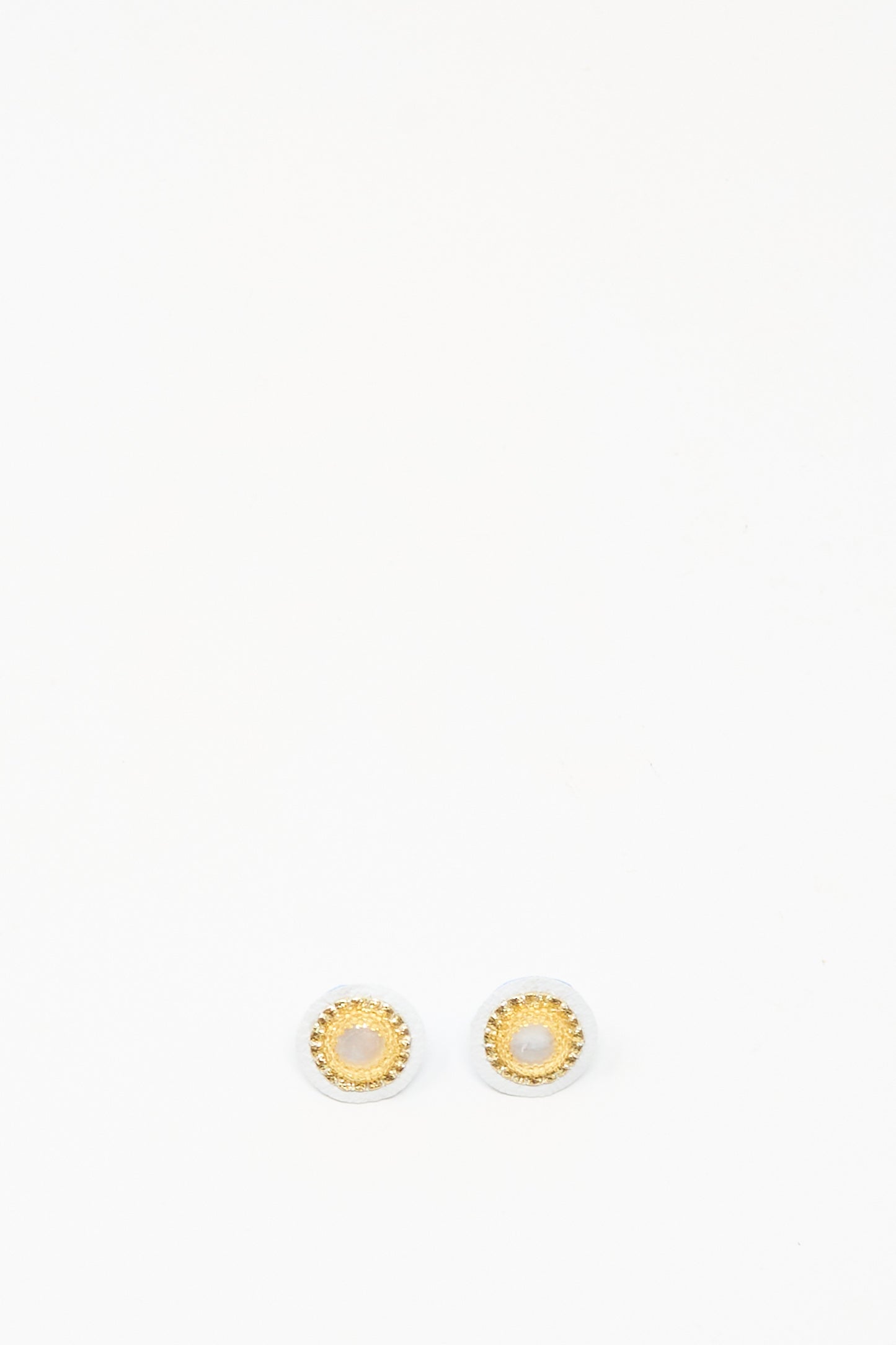 Mother of Pearl Stud Earrings in Gold by Robin Mollicone, featuring round gold and white studs, displayed on a plain white background.
