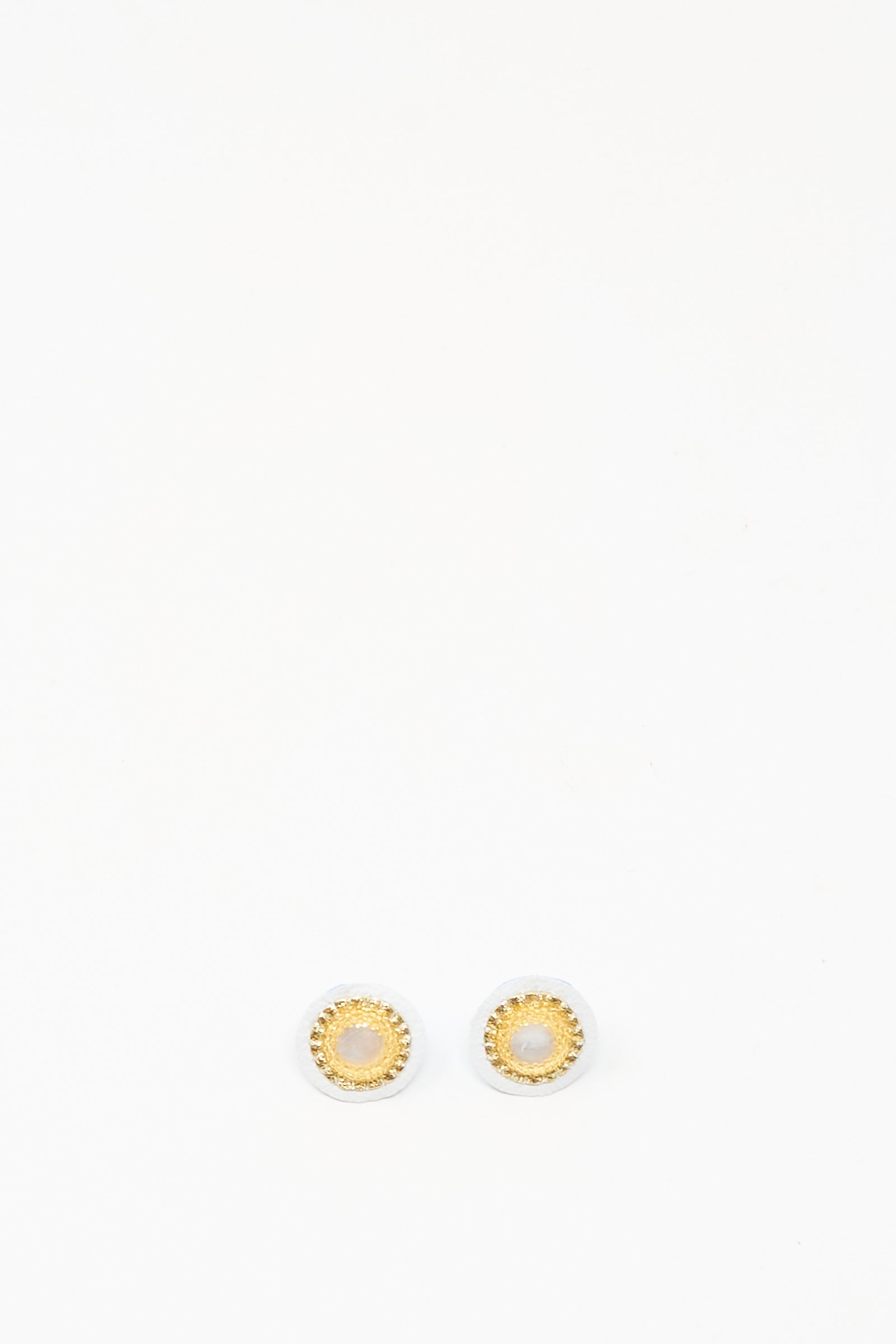 Mother of Pearl Stud Earrings in Gold by Robin Mollicone, featuring round gold and white studs, displayed on a plain white background.