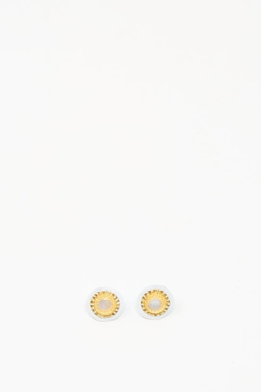 Mother of Pearl Stud Earrings in Gold by Robin Mollicone, featuring round gold and white studs, displayed on a plain white background.