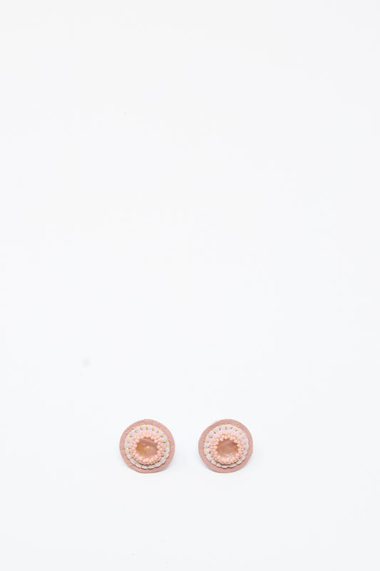 Two Mother of Pearl Stud Earrings in Pink by Robin Mollicone are placed side by side on a plain white background.
