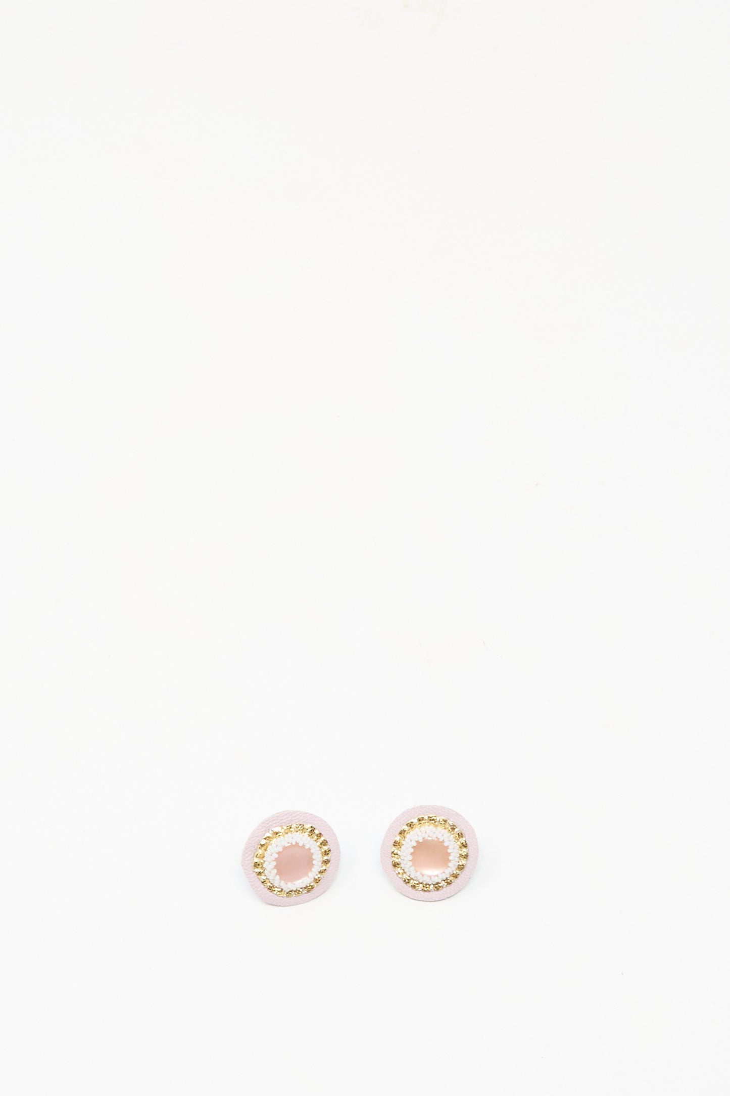 The Robin Mollicone Mother of Pearl Stud Earrings in Pink are round, gold and pink handmade studs shown on a plain white background.