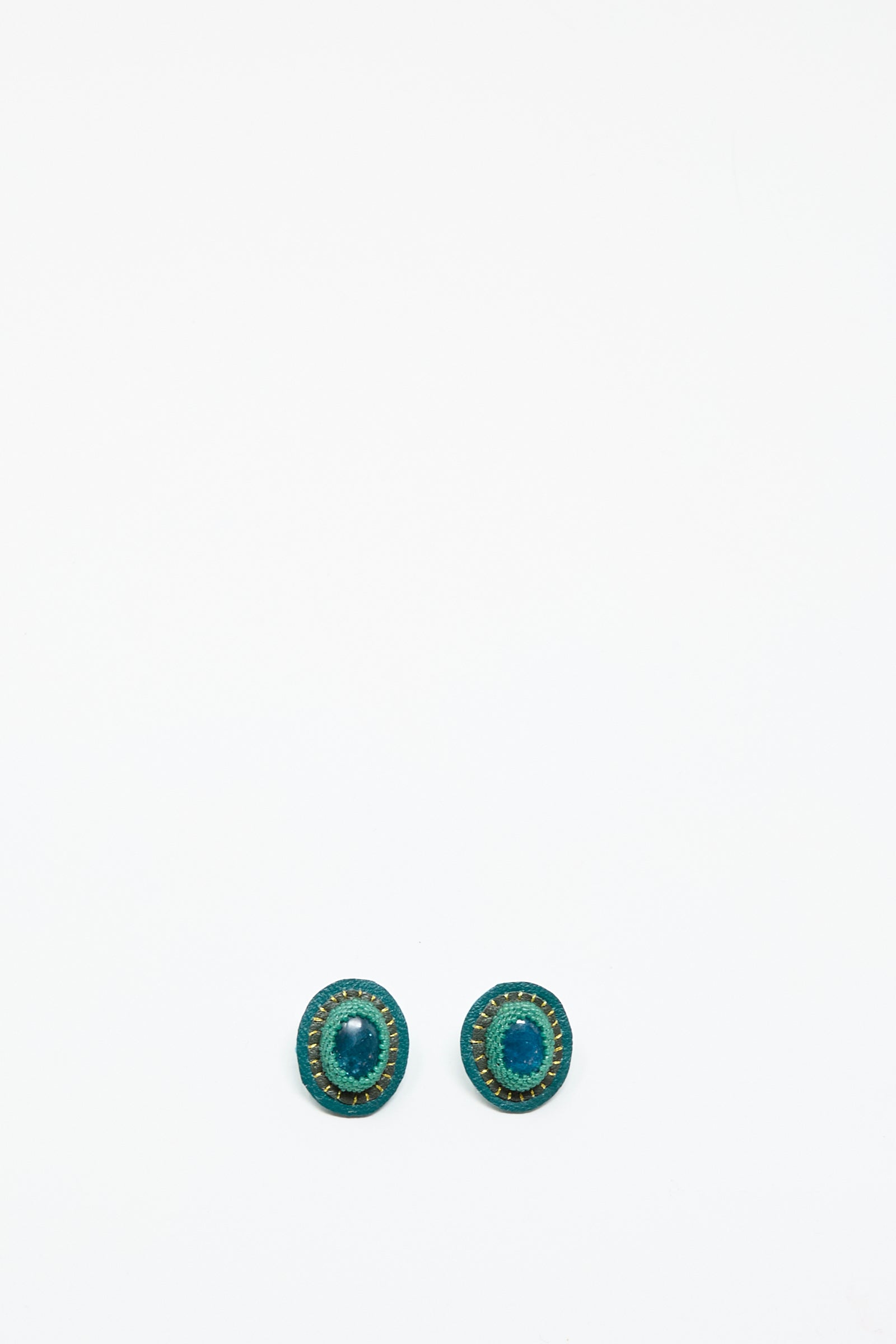 A pair of oval Apatite earrings by Robin Mollicone with gold accents are displayed side by side on a plain white background.