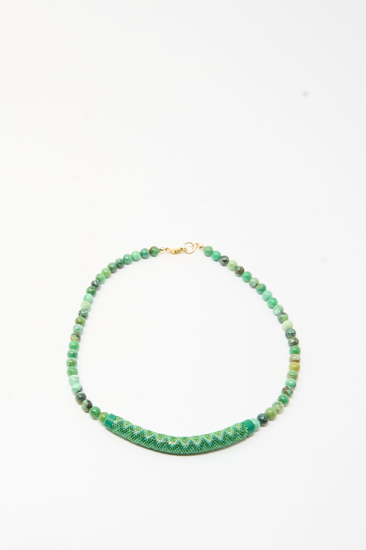 Robin Mollicone Beaded Bar Necklace in Chrysoprase featuring round beads and a curved, bead-woven bar with a geometric pattern.
