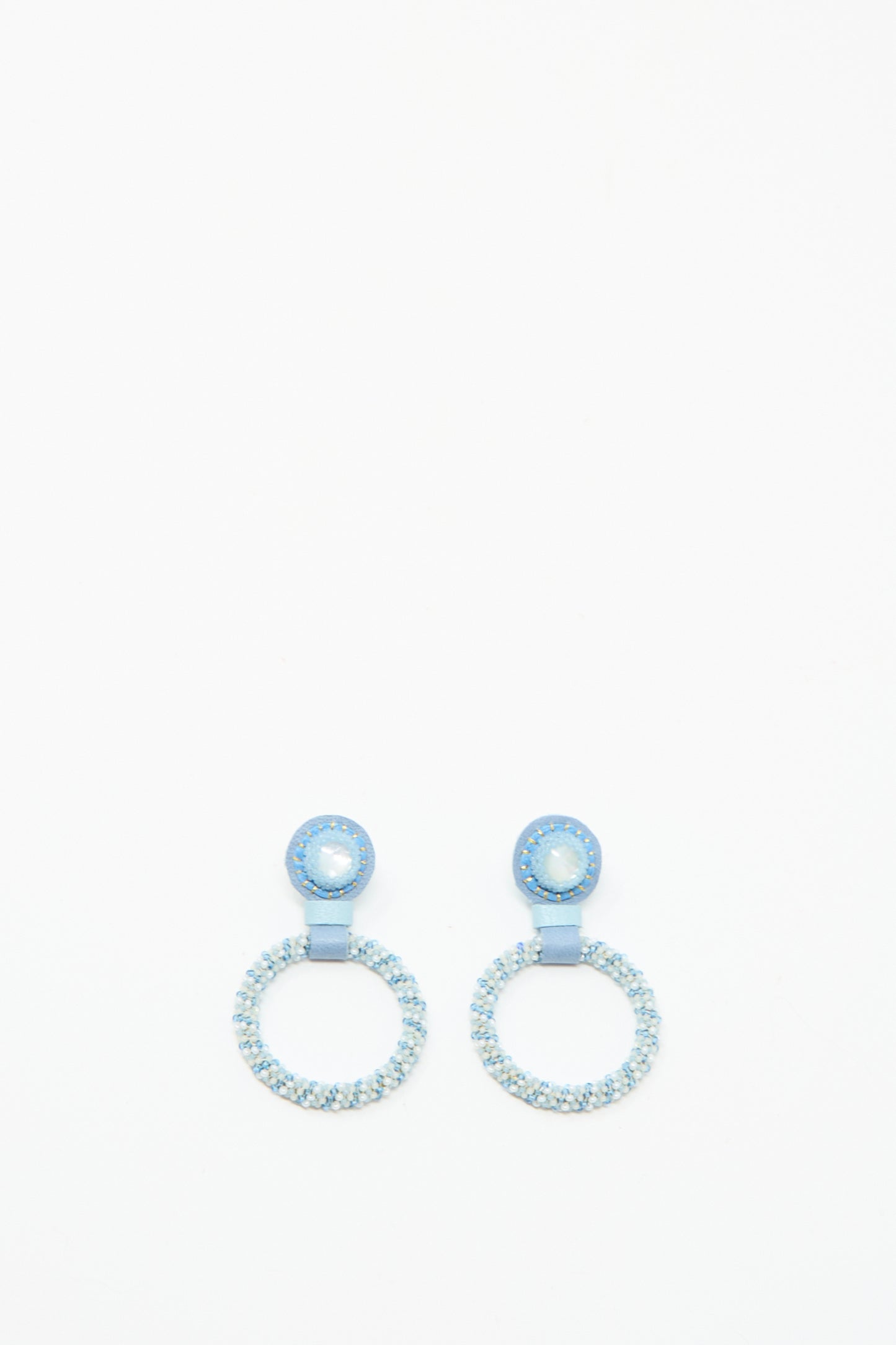 The Small Beaded Hoop Earrings in Mother of Pearl by Robin Mollicone feature circular silver and blue beads with a small round stud and a larger hoop, handmade in NYC and shown on a white background.