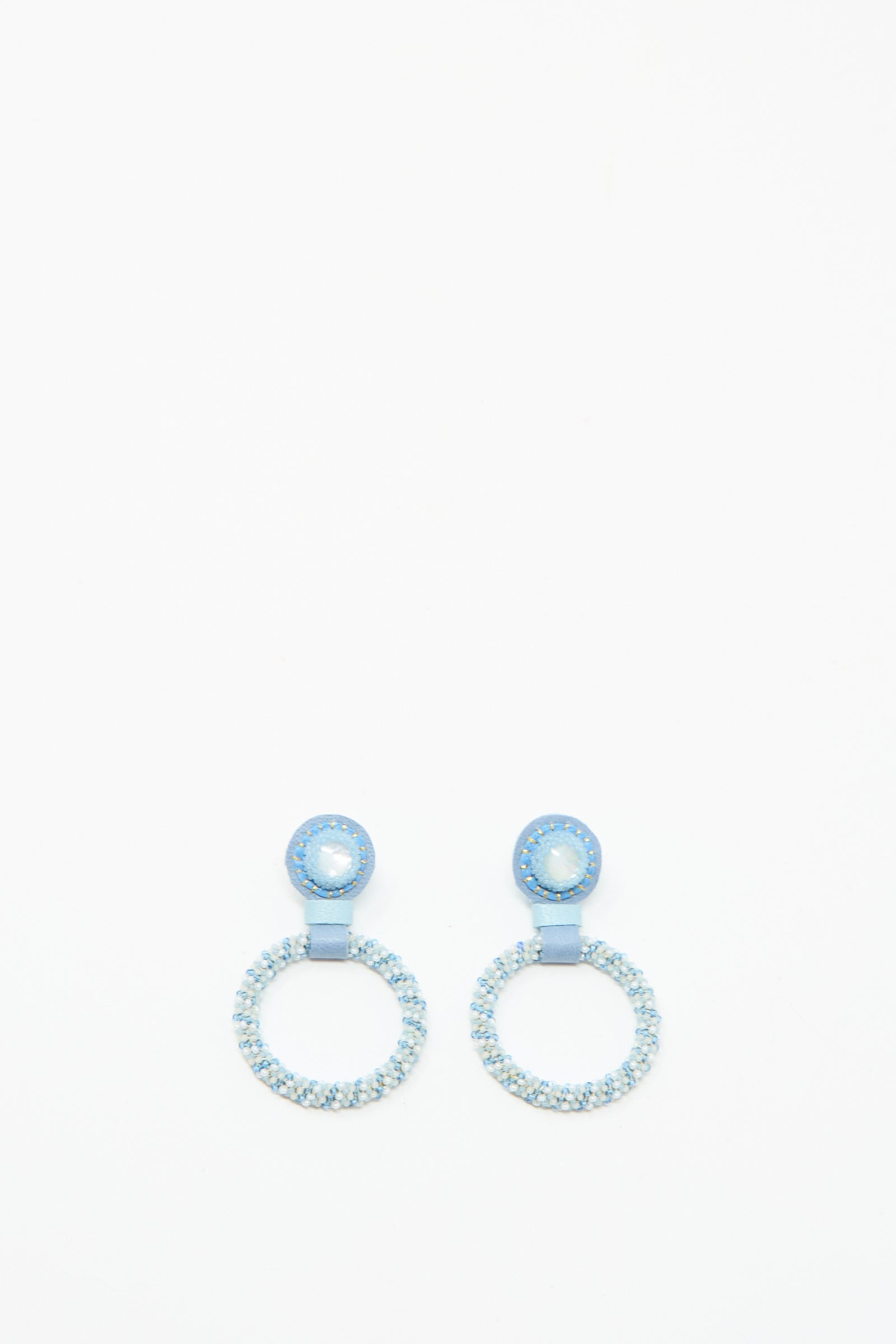 The Small Beaded Hoop Earrings in Mother of Pearl by Robin Mollicone feature circular silver and blue beads with a small round stud and a larger hoop, handmade in NYC and shown on a white background.