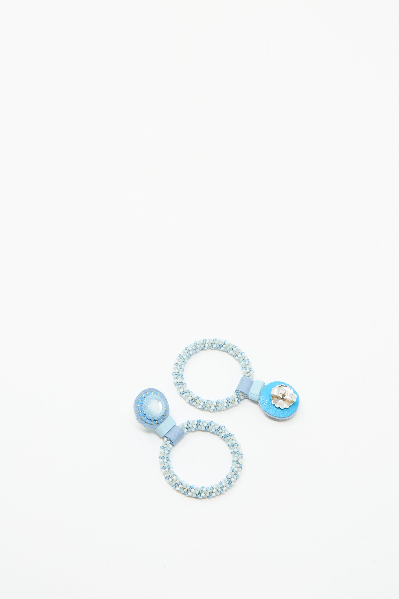 Two Small Beaded Hoop Earrings in Mother of Pearl by Robin Mollicone are handmade in NYC and displayed on a plain white background.