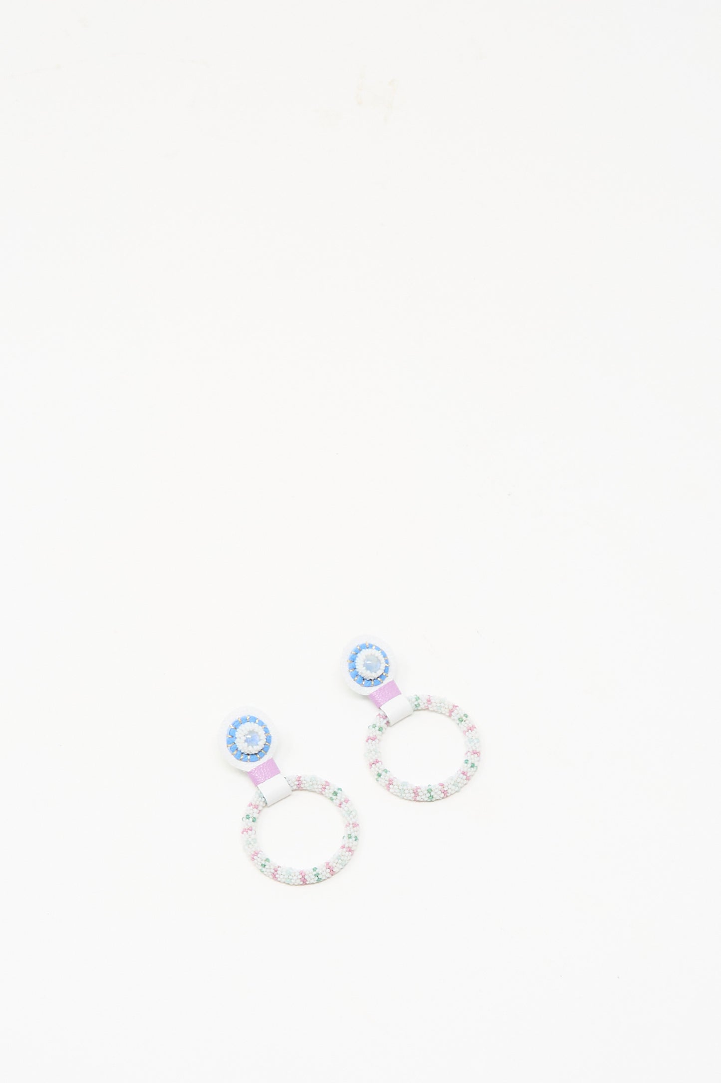 The Small Beaded Hoops in Rainbow Moonstone by Robin Mollicone are handmade earrings with blue and pink detailing, designed as beaded hoops and shown on a white background.
