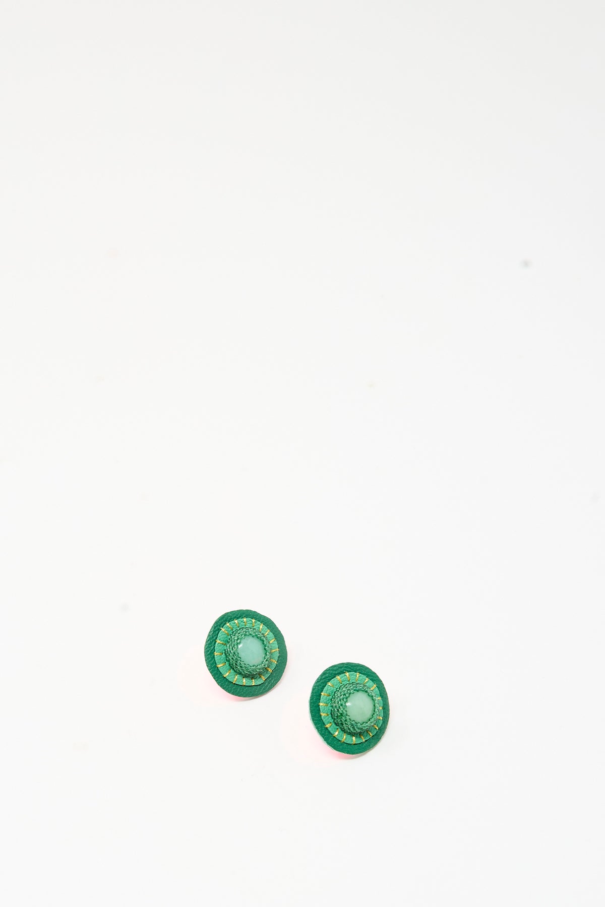 Robin Mollicone Stud Earrings in Chrysoprase featuring a round green design with a central light green stone and gold-tone stitching.