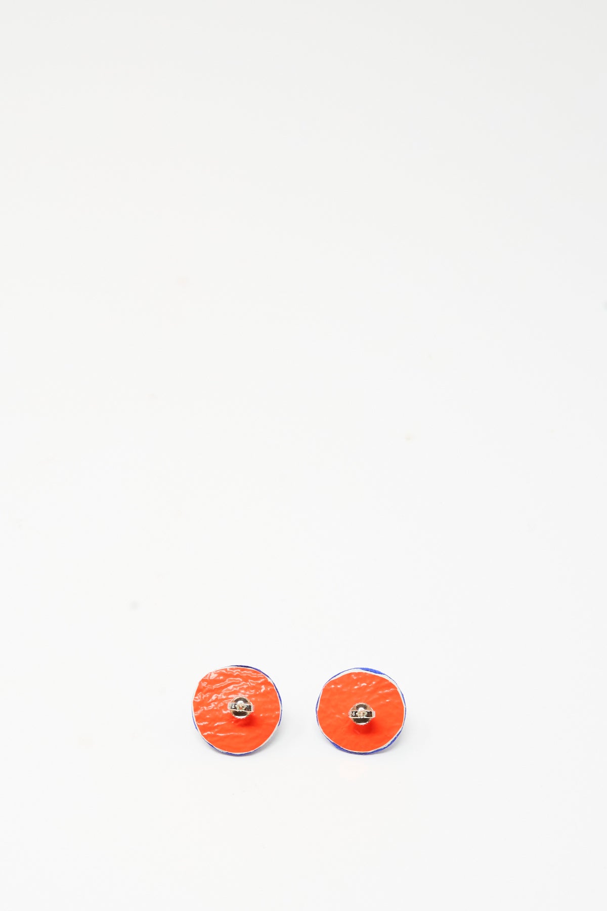 Pair of round, handmade leather Stud Earrings in Lapis featuring orange faces and blue sides.