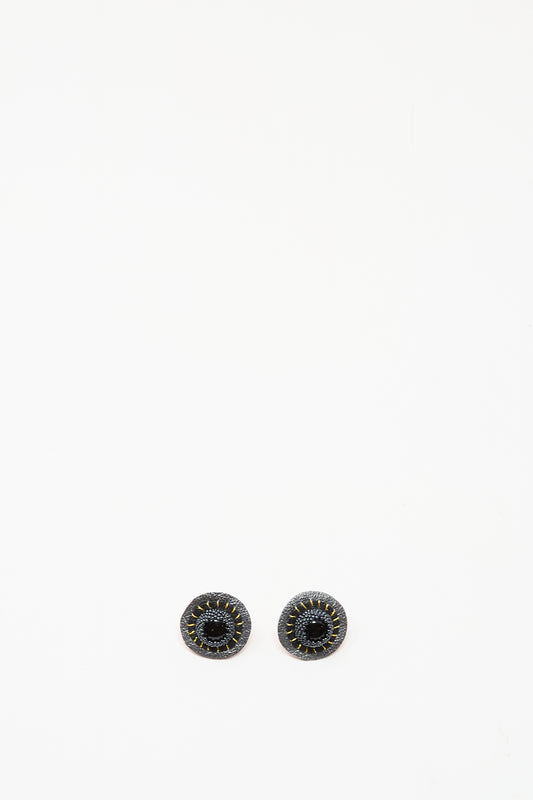 A pair of Robin Mollicone Stud Earrings in Onyx, featuring round black stones with stitched detailing, shown on a plain white background.