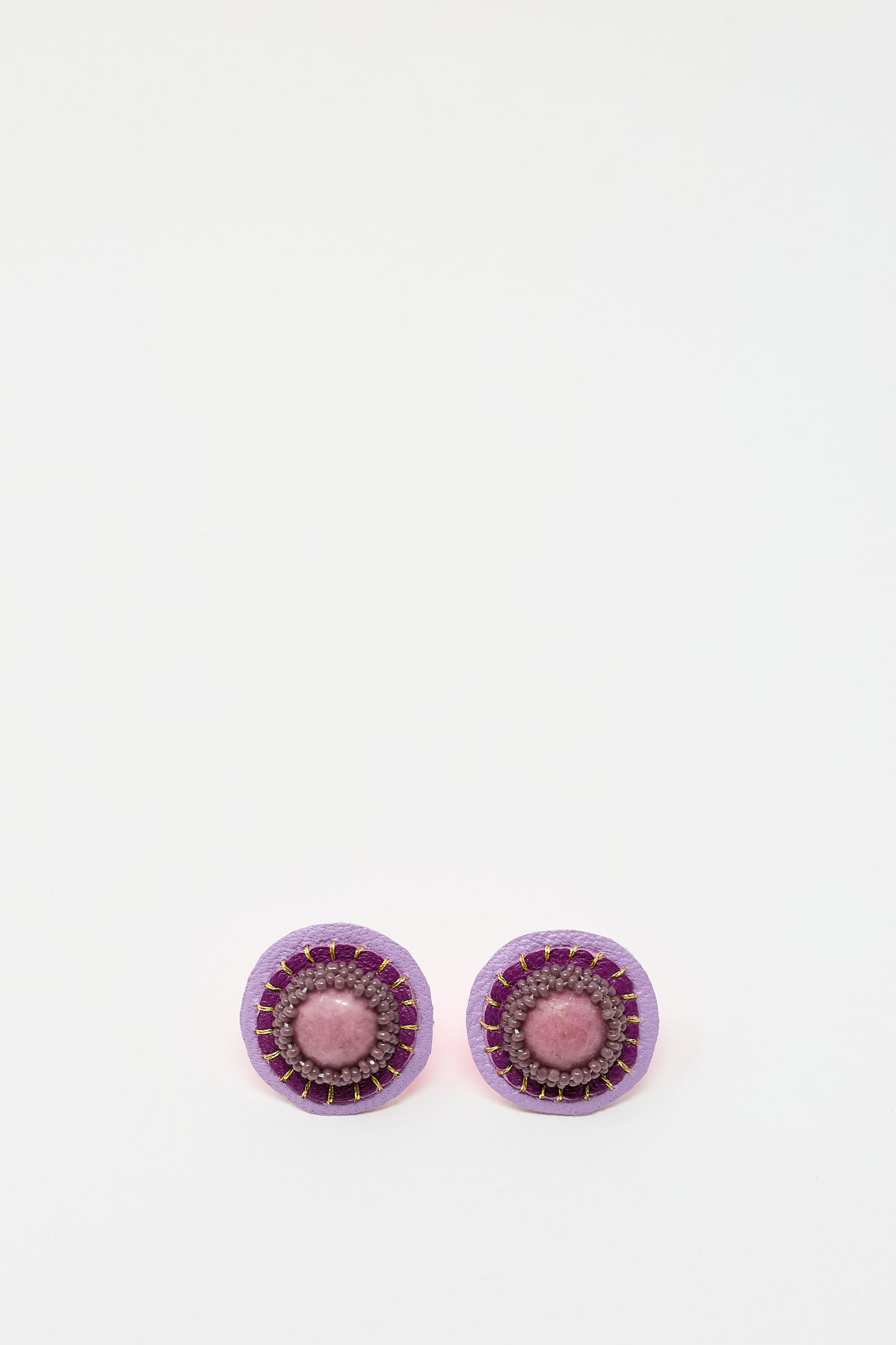 A pair of Robin Mollicone Stud Earrings in Rhodonite featuring a purple outer ring, a pink middle ring, and a central pink rhodonite bead, displayed on a plain white background.