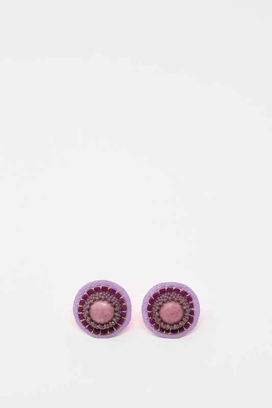 A pair of Robin Mollicone Stud Earrings in Rhodonite featuring a purple outer ring, a pink middle ring, and a central pink rhodonite bead, displayed on a plain white background.